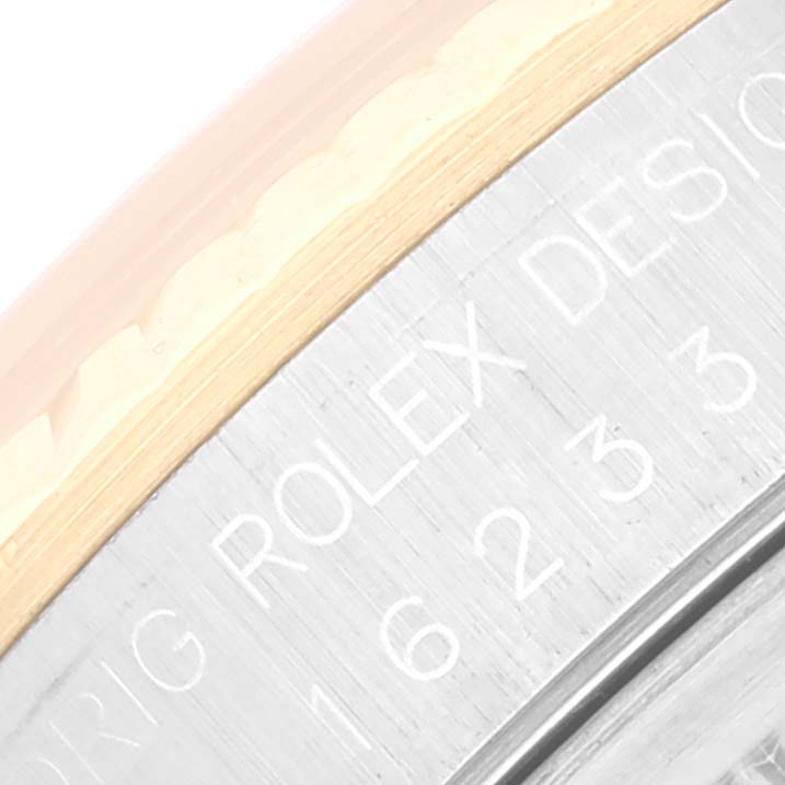 This close-up image shows the engraved lettering on the case of a Rolex Datejust 16233 Men's Steel and Gold (two tone) Champagne Dial 16233 Men's Steel and Gold (two tone) Champagne Dial watch.