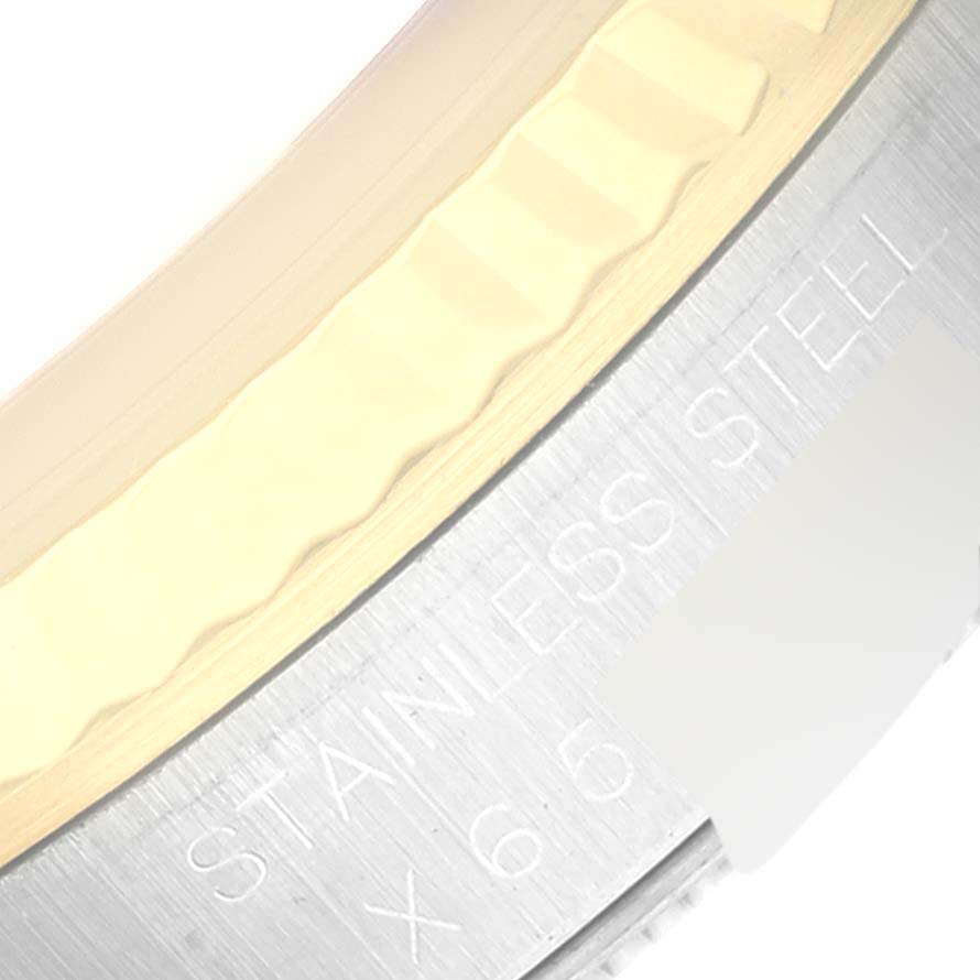This image shows a close-up of the bezel and part of the case of a Rolex Datejust 16233 Men's Steel and Gold (two tone) White Dial 16233 Men's Steel and Gold (two tone) White Dial, highlighting the "STAINLESS STEEL" engraving.