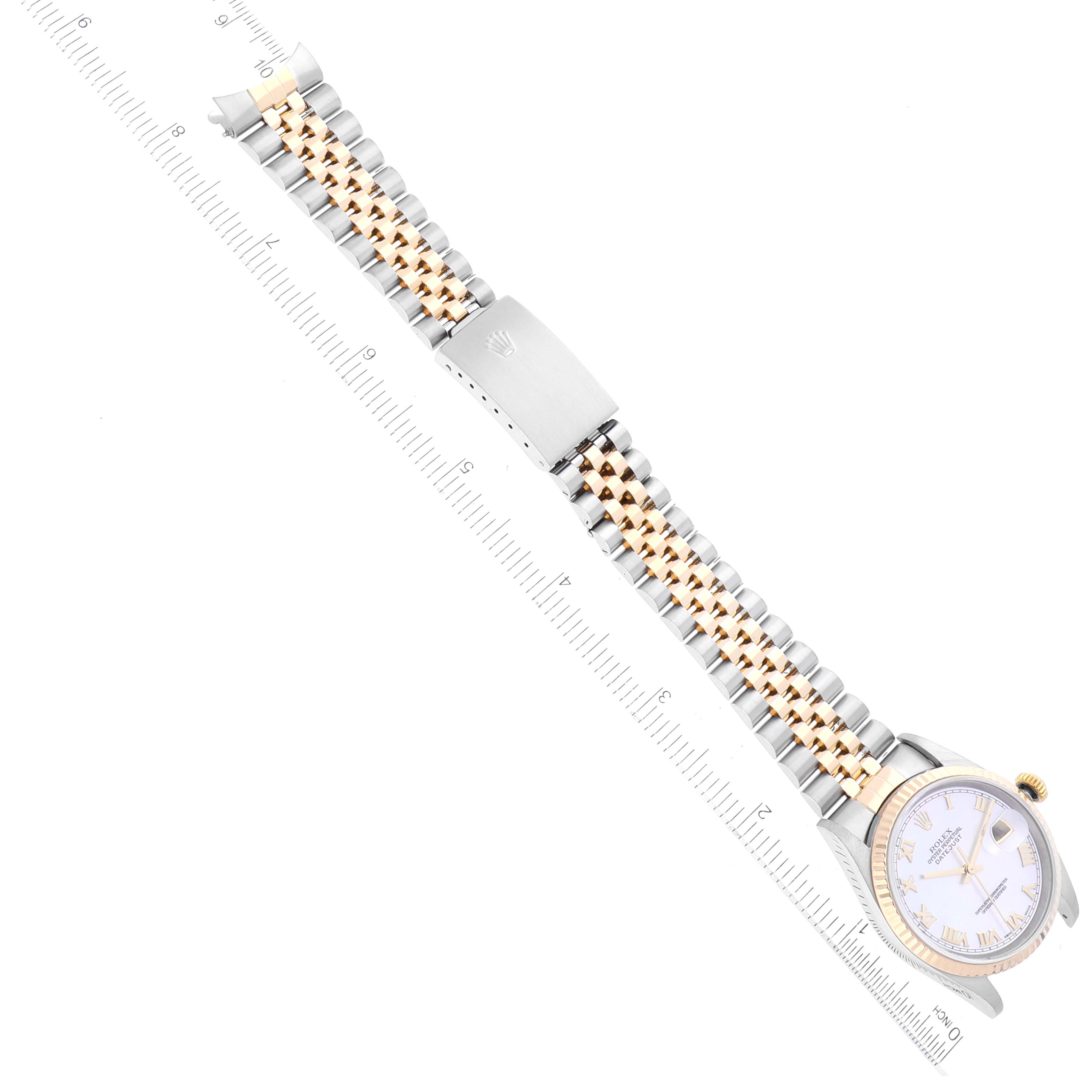 This image shows a Rolex Datejust 16233 Men's Steel and Gold (two tone) Mother of Pearl Dial 16233 Men's Steel and Gold (two tone) Mother of Pearl Dial watch laid flat with a ruler for measurement, displaying the face and full band.