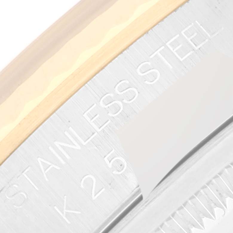 This close-up image shows part of the stainless steel and gold bezel of a Rolex Datejust 16233 Men's Steel and Gold (two tone) Mother of Pearl Dial 16233 Men's Steel and Gold (two tone) Mother of Pearl Dial watch.