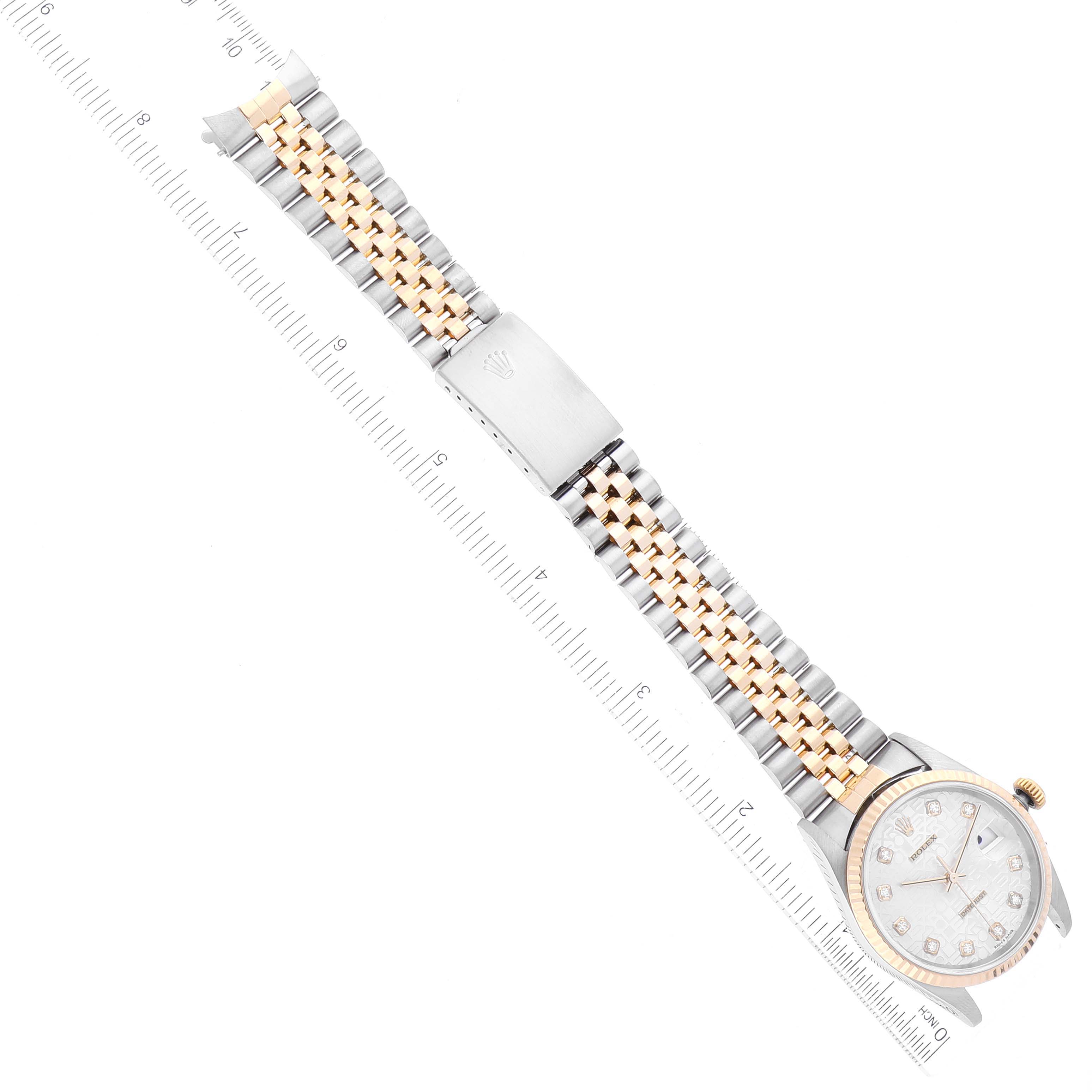 The image shows a top-down view of a Rolex Datejust 16233 Men's Steel and Gold (two tone) Silver Dial 16233 Men's Steel and Gold (two tone) Silver Dial watch focusing on the face, bracelet, and clasp positioned along a ruler.