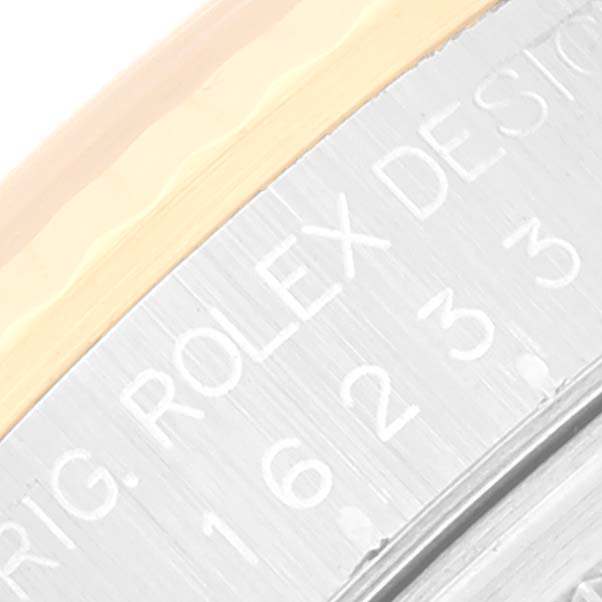 The image shows a close-up of the side engraving on a Rolex Datejust 16233 Men's Steel and Gold (two tone) Silver Dial 16233 Men's Steel and Gold (two tone) Silver Dial model.