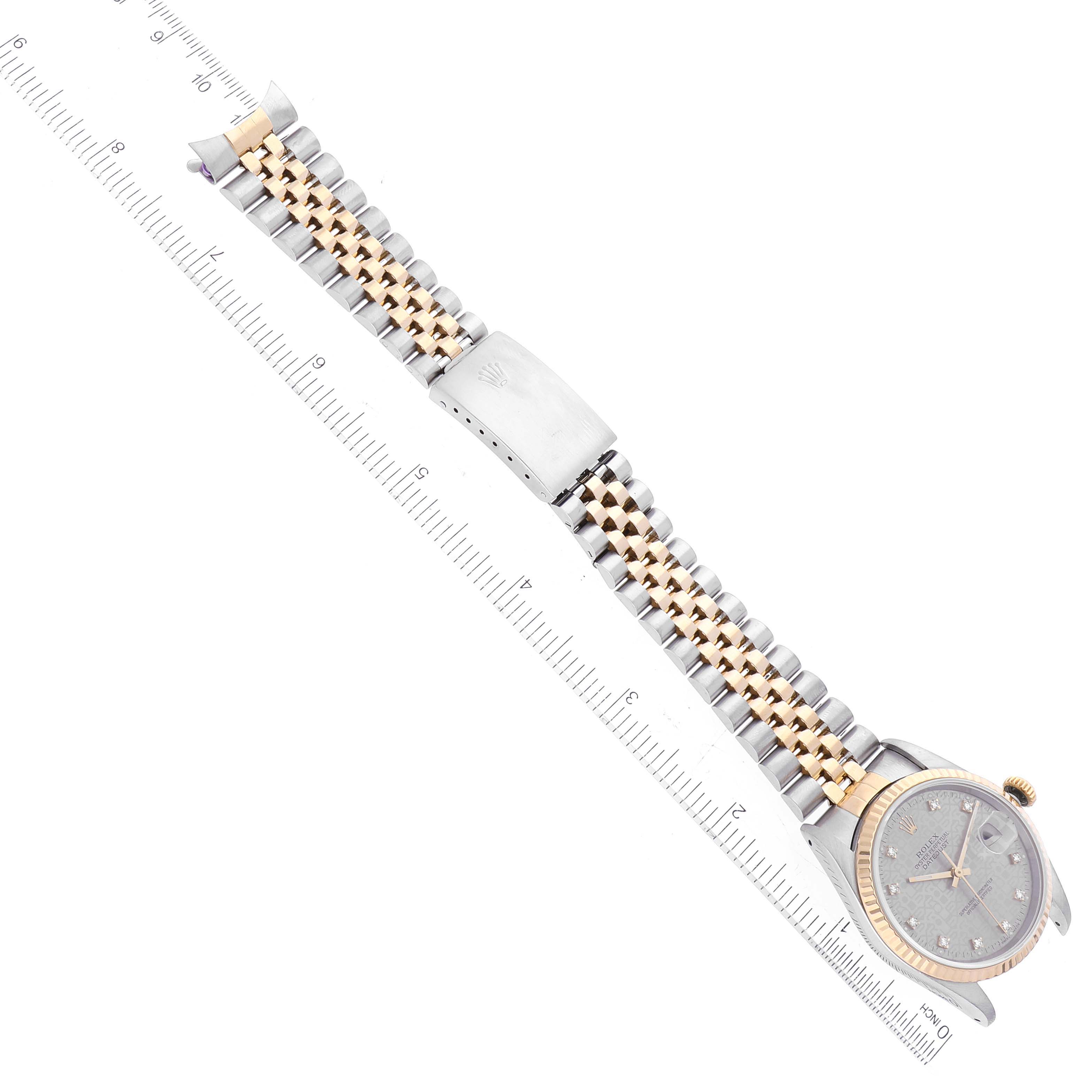 The image shows a Rolex Datejust 16233 Men's Steel and Gold (two tone) Silver Dial 16233 Men's Steel and Gold (two tone) Silver Dial watch laid flat with a measuring ruler positioned alongside its two-tone bracelet and clasp.