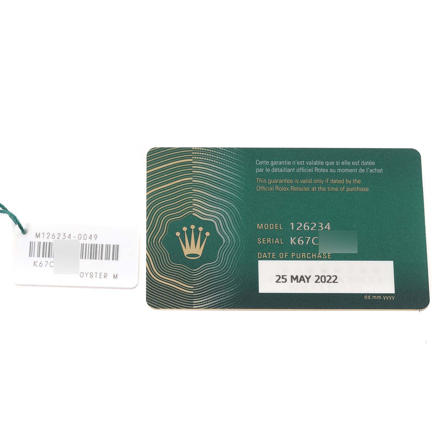 The image shows a warranty card and a tag for a Rolex Datejust 126234 Men's Stainless Steel Blue Dial 126234 Men's Stainless Steel Blue Dial model, capturing them from a top-down angle.