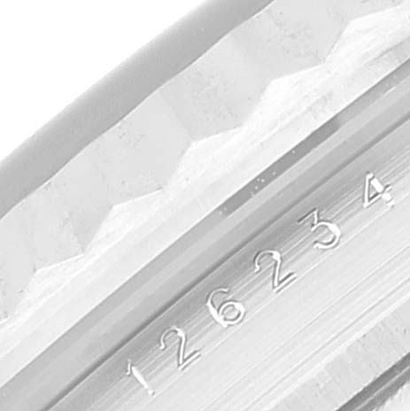 The image shows a close-up of the fluted bezel and the serial number engraving on a Rolex Datejust 126234 Men's Stainless Steel Blue Dial 126234 Men's Stainless Steel Blue Dial watch case.