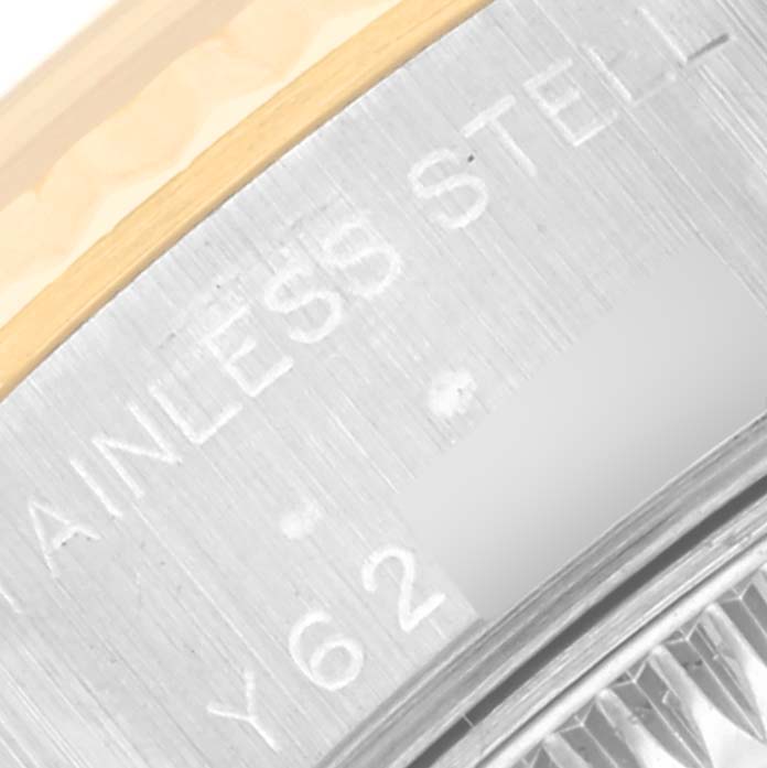 The image shows a close-up of the side of a Rolex Datejust 79173 Women's Steel and Gold (two tone) Silver Dial 79173 Women's Steel and Gold (two tone) Silver Dial watch, focusing on the stainless steel and gold edge with engraved text.