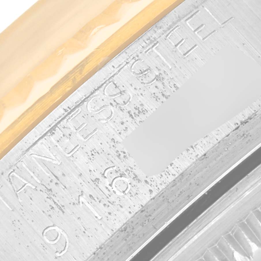 This close-up photo shows the engraved stainless steel and gold portions of the Rolex Vintage Collection 16013 Men's Steel and Gold (two tone) Champagne Dial 16013 Men's Steel and Gold (two tone) Champagne Dial watch bezel.