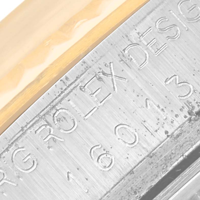 The image shows a close-up of the engraved side of a Rolex Vintage Collection 16013 Men's Steel and Gold (two tone) Champagne Dial 16013 Men's Steel and Gold (two tone) Champagne Dial watch.