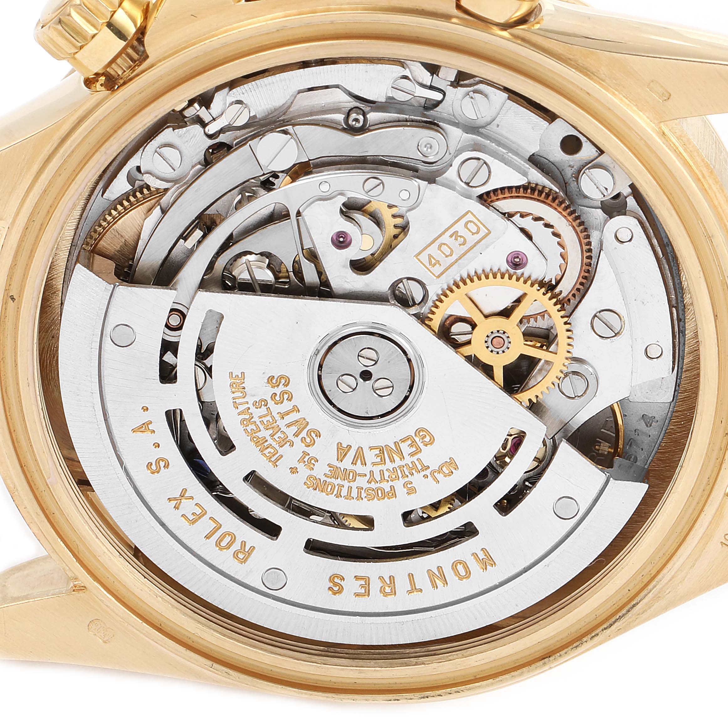 The image shows the back view of a Rolex Daytona 16528 Men's Yellow Gold Black Dial 16528 Men's Yellow Gold Black Dial watch, revealing its intricate mechanical movement and gears.