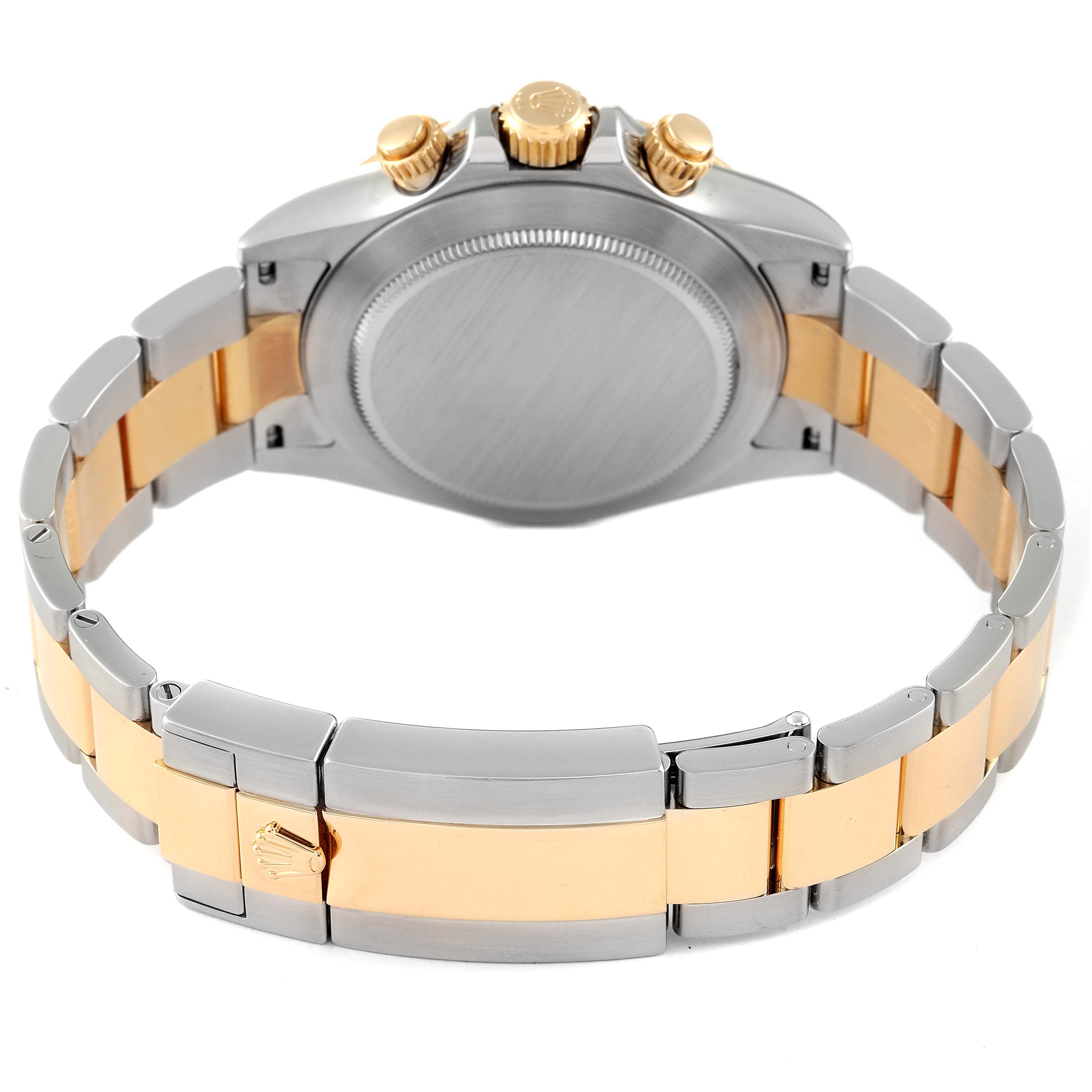 The image shows the back case, crown, and part of the bracelet of a Rolex Daytona 116523 Men's Steel and Gold (two tone) Mother of Pearl Dial 116523 Men's Steel and Gold (two tone) Mother of Pearl Dial watch.