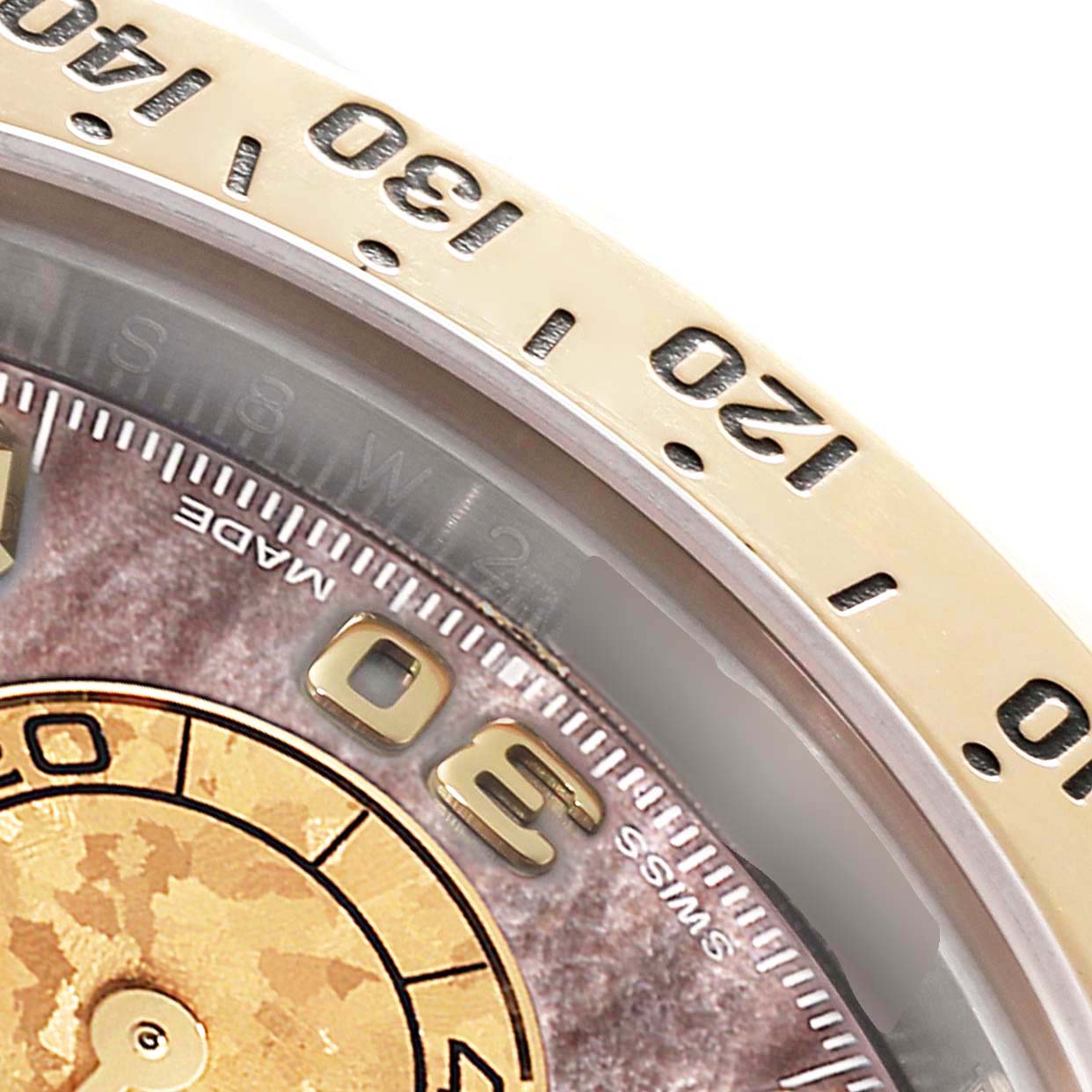 This close-up image shows the bezel, numbers, and part of the dial of a Rolex Daytona 116523 Men's Steel and Gold (two tone) Mother of Pearl Dial 116523 Men's Steel and Gold (two tone) Mother of Pearl Dial watch.