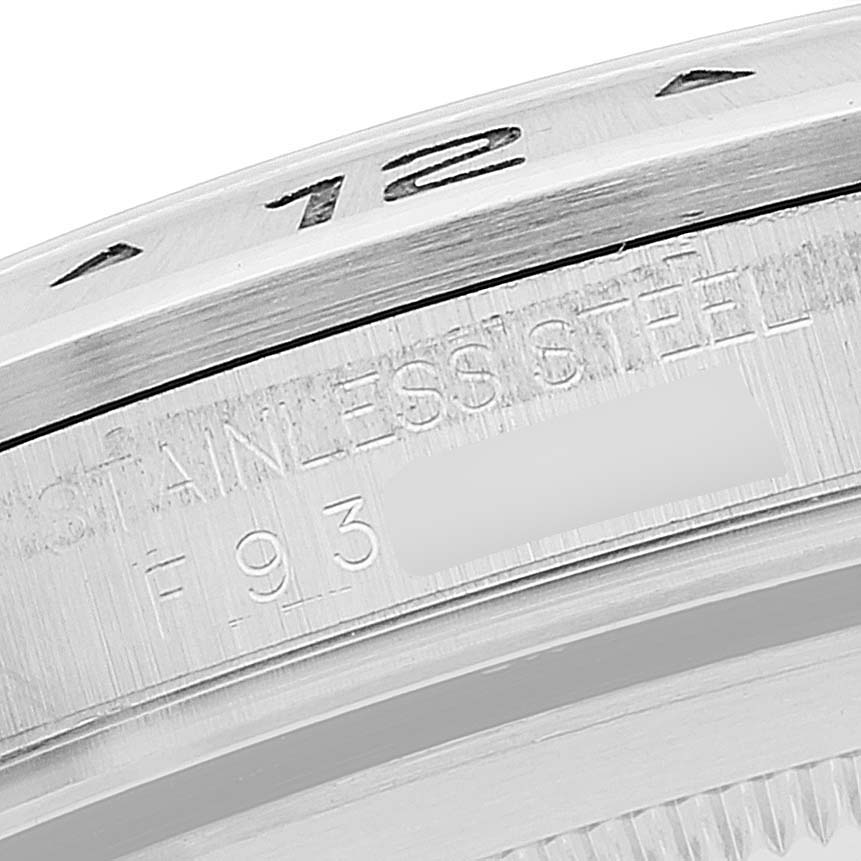 This image shows a close-up of the bezel and part of the casing with text on a Rolex Explorer 16570 Men's Stainless Steel White Dial 16570 Men's Stainless Steel White Dial watch in a macro perspective.
