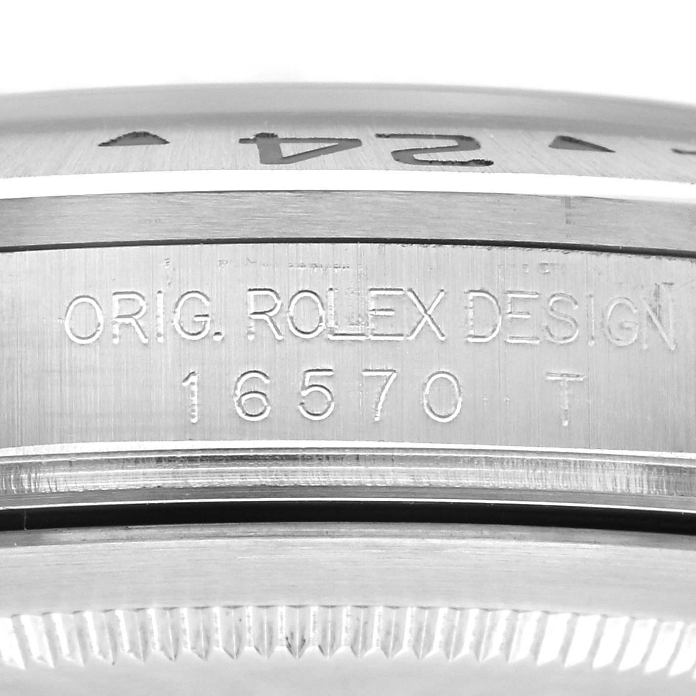 The image shows a close-up of the side of the case of a Rolex Explorer 16570 Men
s Stainless Steel Black Dial 16570 Men
s Stainless Steel Black Dial, highlighting the engraved model number, "16570 T".