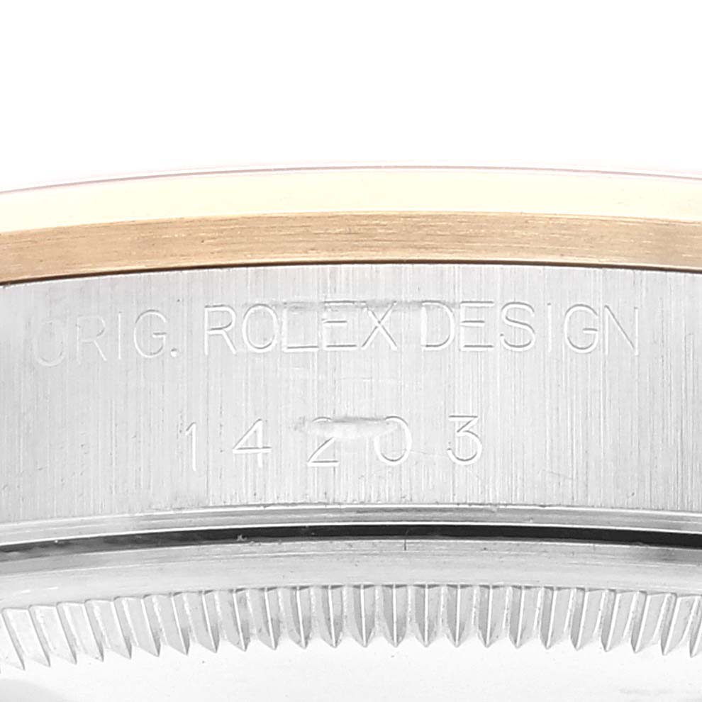 This image shows the side of the case and the bezel of a Rolex Oyster Perpetual 14203 Men's Steel and Gold (two tone) Grey Dial 14203 Men's Steel and Gold (two tone) Grey Dial watch, featuring the engraved model number.