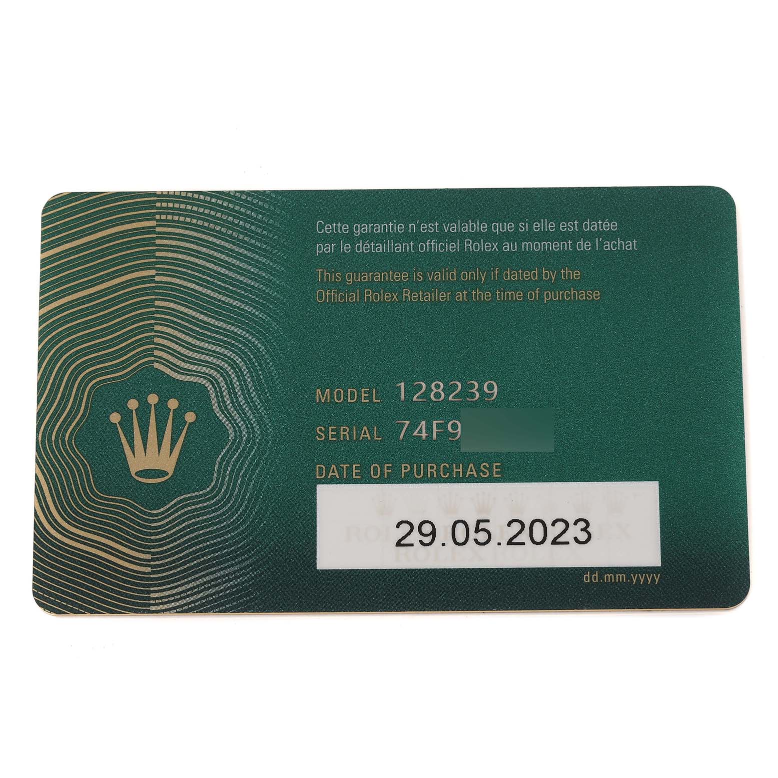 This image shows a warranty card for the Rolex President 128239 Men's White Gold Blue Dial 128239 Men's White Gold Blue Dial model 128239, displaying the serial number and date of purchase.