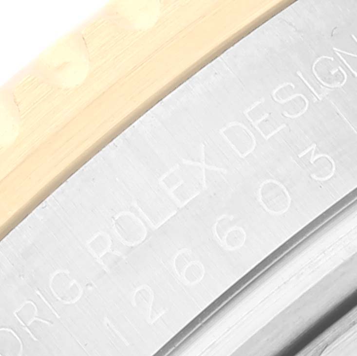 This close-up image of a Rolex Sea-Dweller 126603 Men's Steel and Gold (two tone) Black Dial 126603 Men's Steel and Gold (two tone) Black Dial watch shows the bezel and partially visible engraved case number.