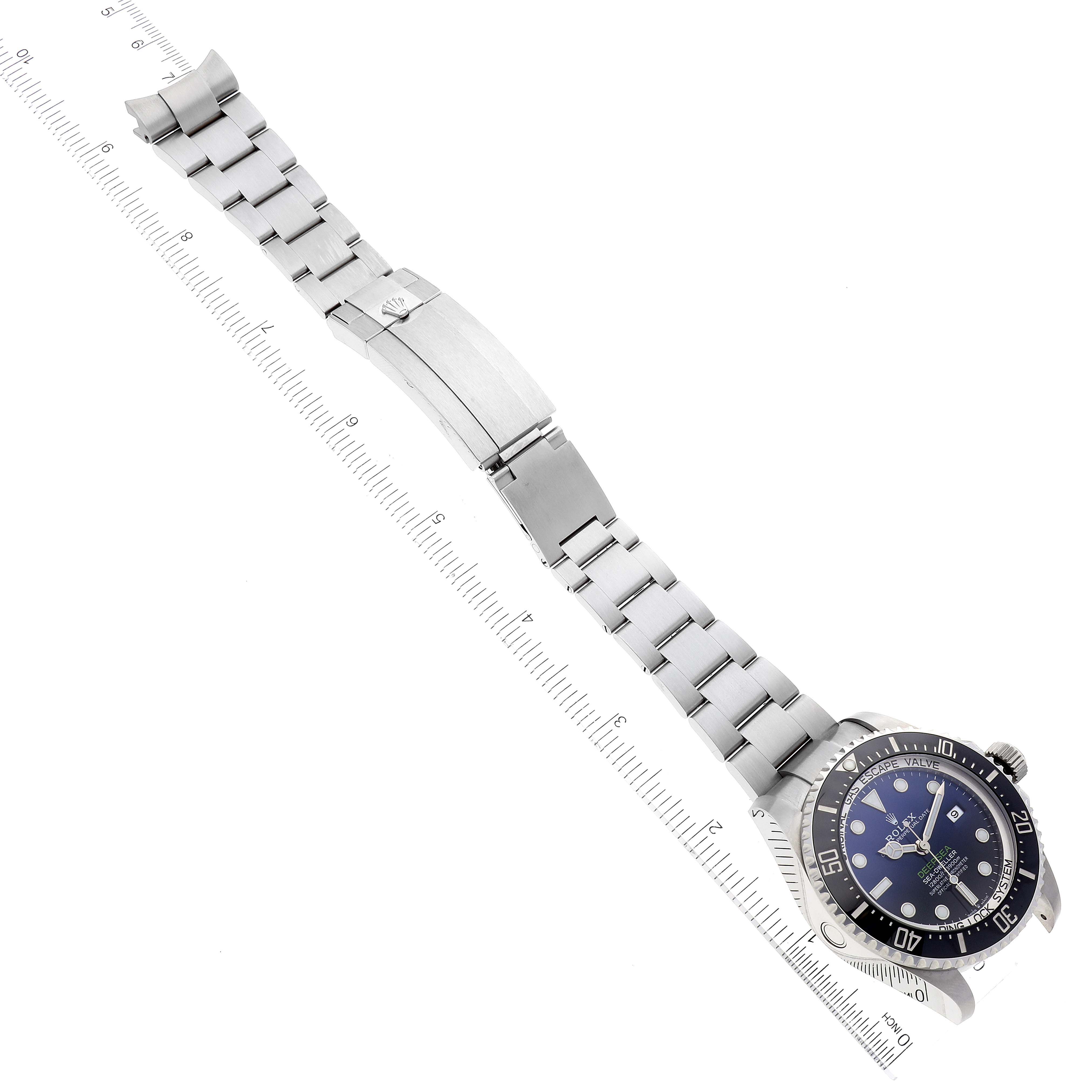 The image shows a fully extended Rolex Sea-Dweller 126660 Men's Stainless Steel Blue Dial 126660 Men's Stainless Steel Blue Dial watch with its bracelet unfolded, laid flat with a ruler for scale.