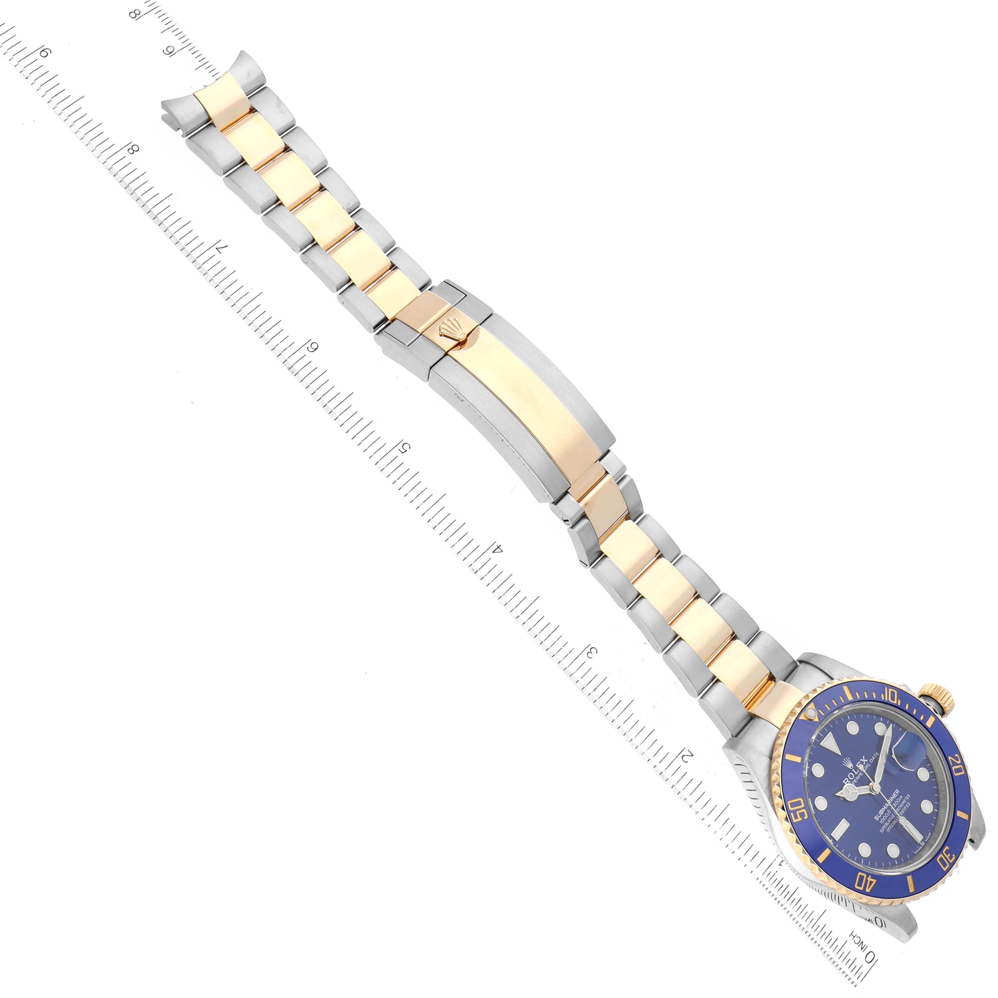 The image shows a top-down view of a Rolex Submariner 126613LB Men's Steel and Gold (two tone) Blue Dial 126613LB Men's Steel and Gold (two tone) Blue Dial watch featuring its bracelet, clasp, and dial.