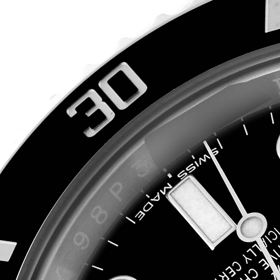 The image shows a close-up of the bezel and part of the dial of a Rolex Submariner 114060 Men
s Stainless Steel Black Dial 114060 Men
s Stainless Steel Black Dial watch, focusing on the 30-minute mark.