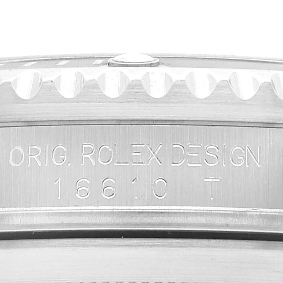 The image shows the engraved case side of a Rolex Submariner 16610LV Men's Stainless Steel Black Dial 16610LV Men's Stainless Steel Black Dial with the text "ORIG. ROLEX DESIGN 16610T."