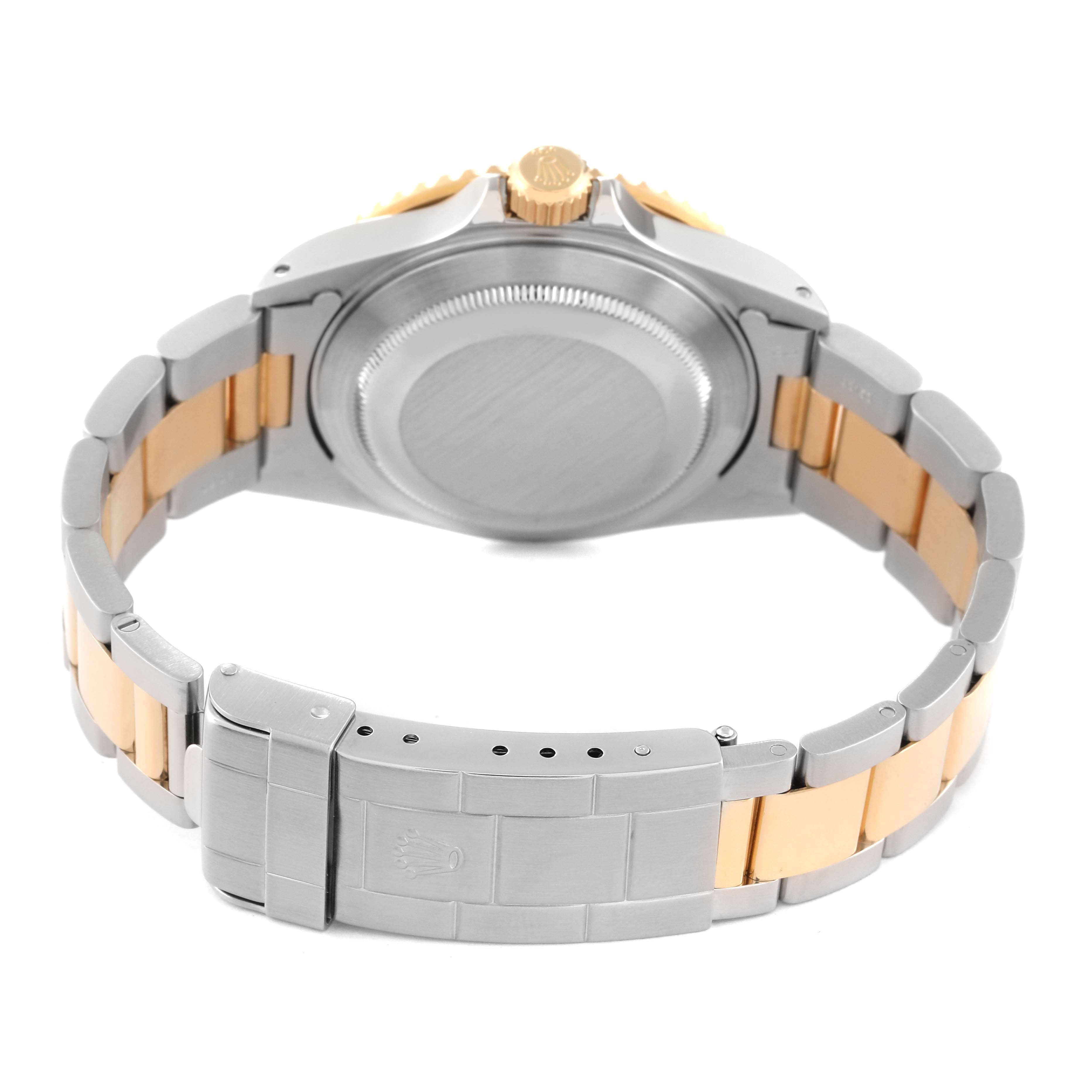 The image shows the backside of a Rolex Submariner 16613 Men's Steel and Gold (two tone) Black Dial 16613 Men's Steel and Gold (two tone) Black Dial with focus on the clasp, bracelet, and case back.