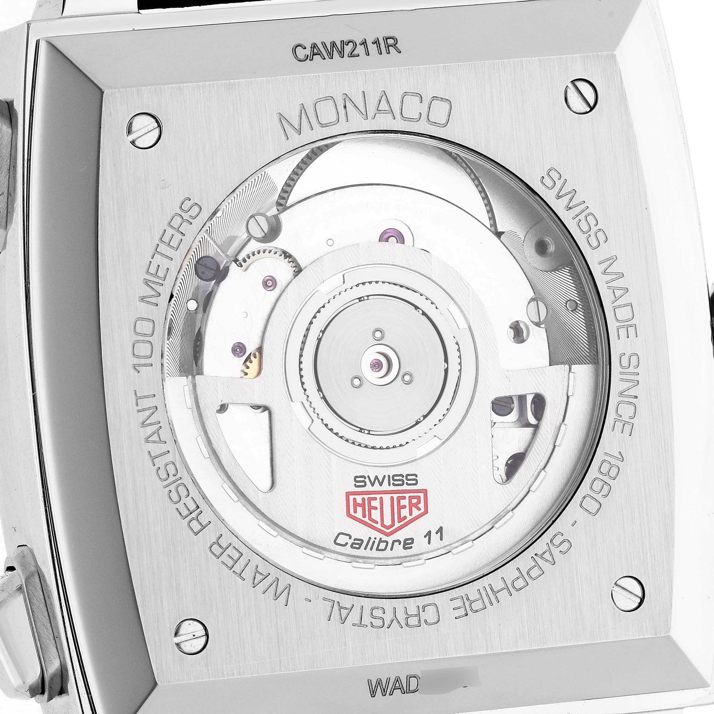 The image shows the back view of the Tag Heuer Monaco CAW211R Men
s Stainless Steel Blue Dial model, highlighting its movement and inscriptions.