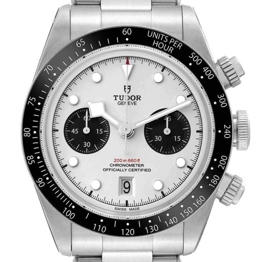 The image shows a front view of a Tudor Heritage Black Bay watch, featuring a white dial, black sub-dials, and a stainless steel bracelet.