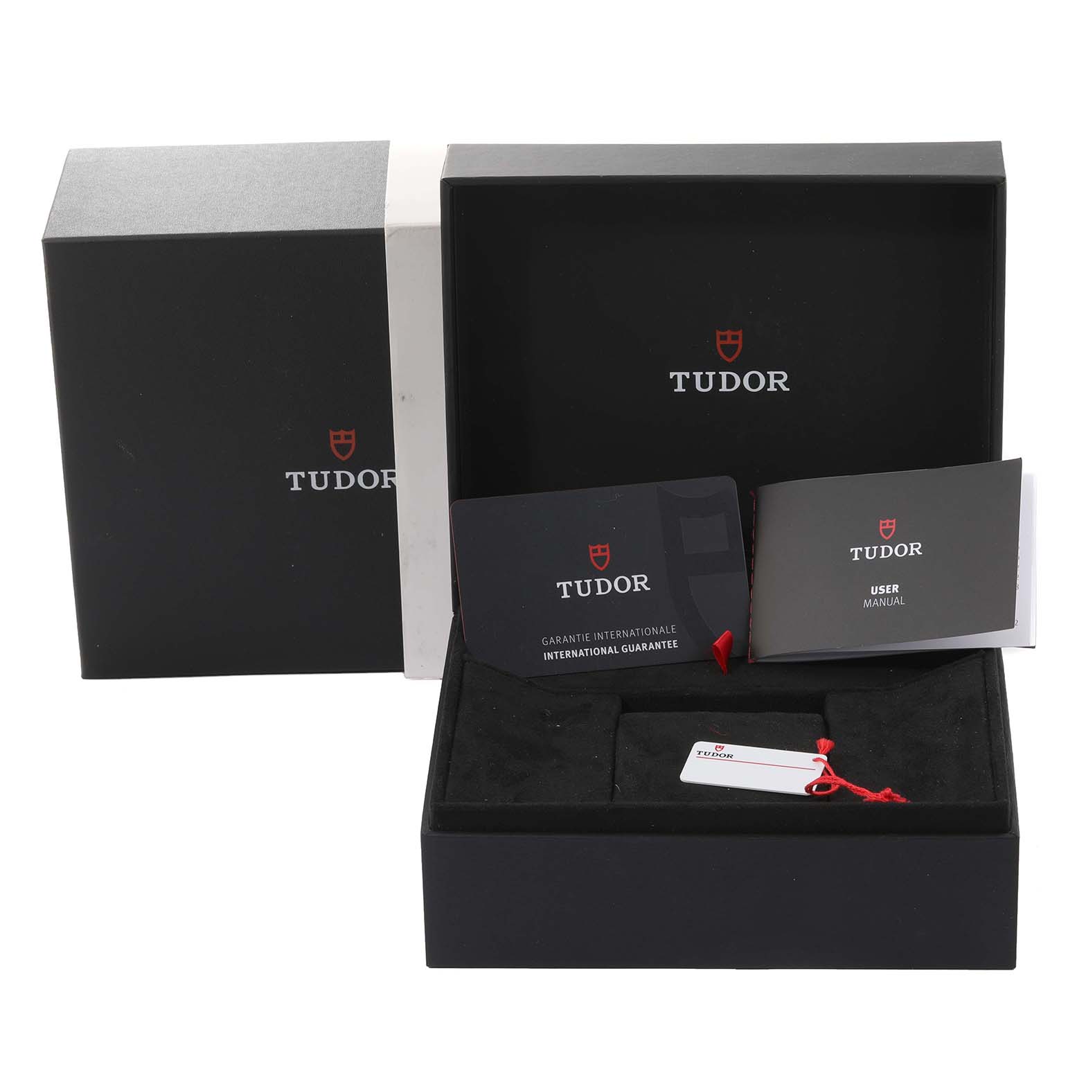 The image shows the packaging and accessories for a Tudor Heritage Black Bay M79360N-002 Men's Stainless Steel Silver Dial M79360N-002 Men's Stainless Steel Silver Dial watch, including the box, manuals, and warranty card.