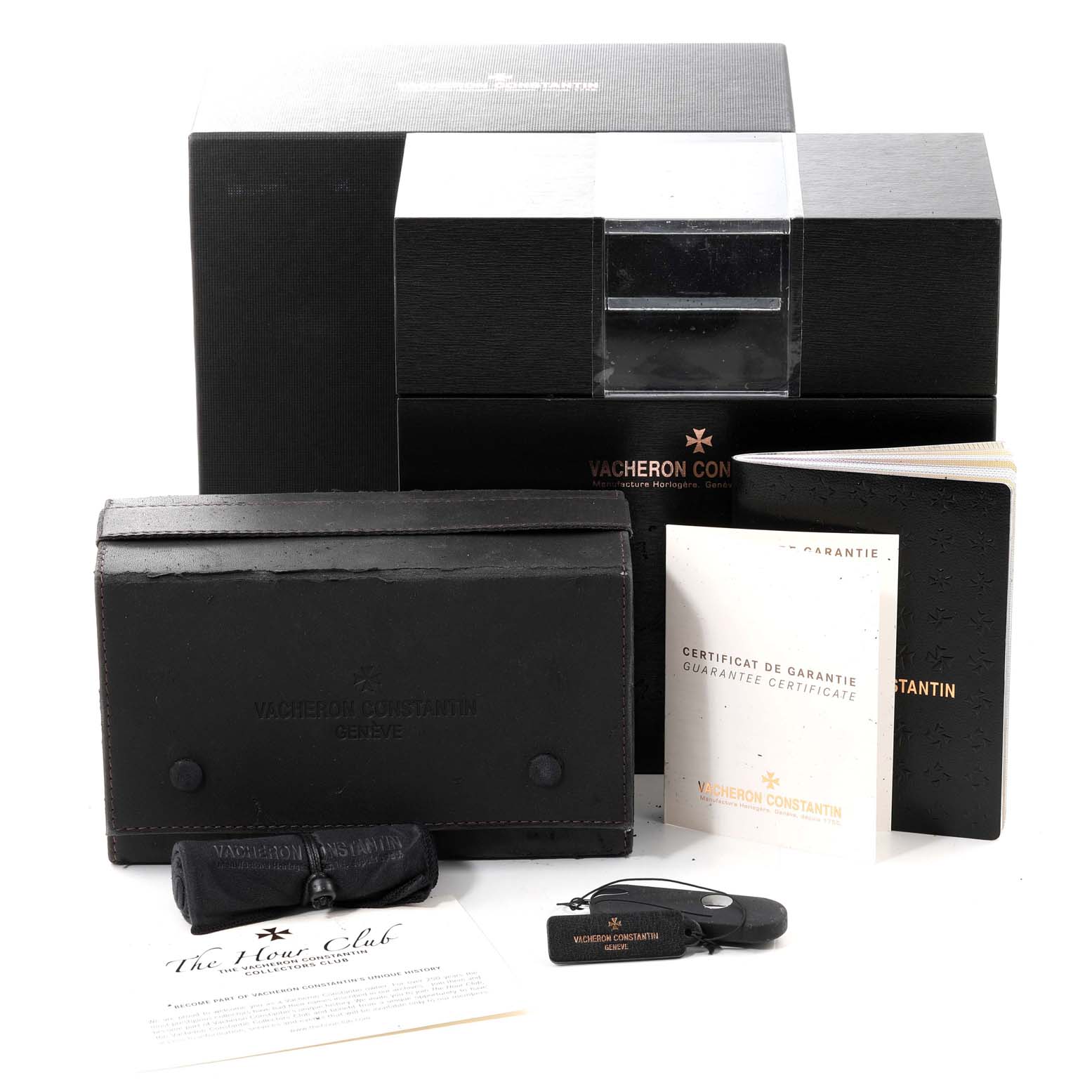 The image shows Vacheron Constantin Overseas 47040B01A-9093 Men
s Stainless Steel Silver Dial 47040B01A-9093 Men
s Stainless Steel Silver Dial watch accessories, including boxes, manuals, a keychain, and a warranty certificate, from a front view.