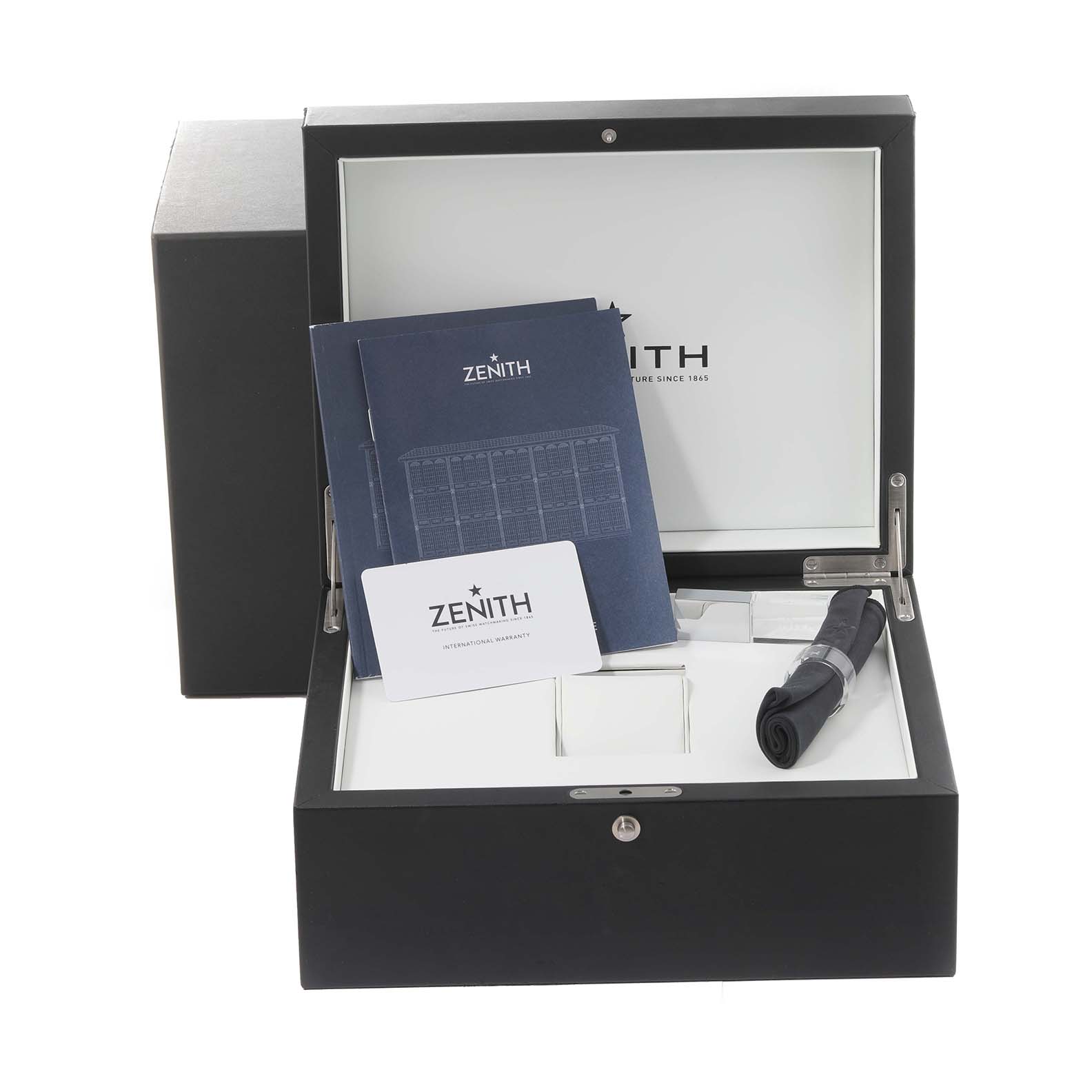 The image shows a Zenith Chronomaster 03.3100.3600/69.M3100 Men's Stainless Steel White Dial 03.3100.3600/69.M3100 Men's Stainless Steel White Dial watch packaging, including the warranty card, manual, and additional accessories.