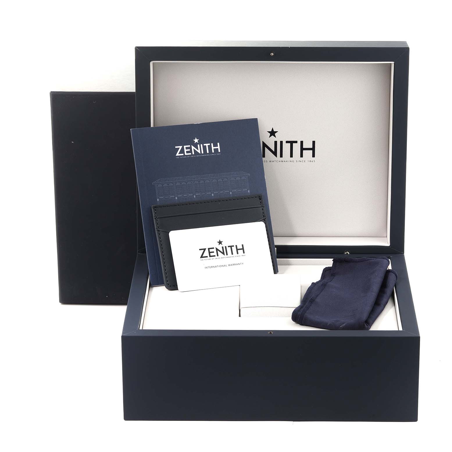 The image shows the packaging of a Zenith Chronomaster 03.3108.3600/57.M3100 Men's Stainless Steel Green Dial 03.3108.3600/57.M3100 Men's Stainless Steel Green Dial watch, including the box, warranty cards, documentation, and cloth.