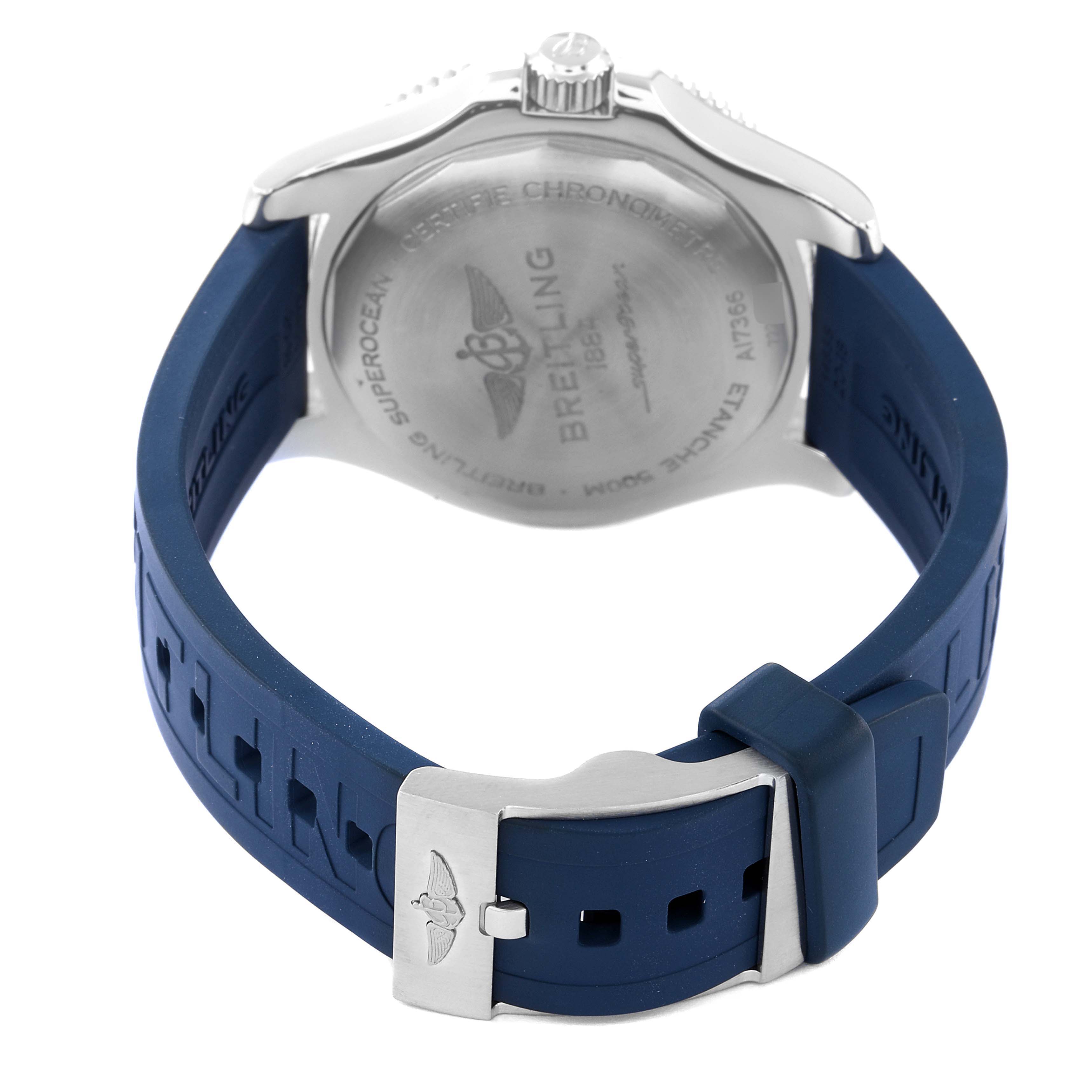 The image shows the back view of a Breitling Superocean A17366 Men
s Stainless Steel White Dial A17366 Men
s Stainless Steel White Dial watch, focusing on its case back, crown, and blue rubber strap with a clasp.
