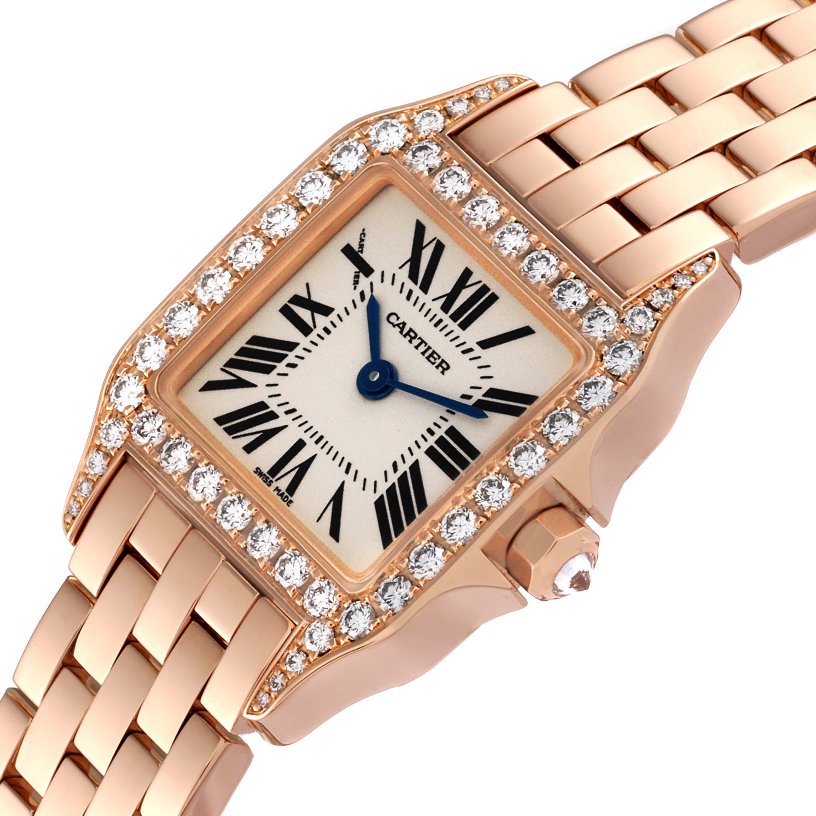 The Cartier Santos Demoiselle WF9011Z8 Women's Rose Gold Silver Dial WF9011Z8 Women's Rose Gold Silver Dial watch is shown at an angle highlighting its diamond-studded bezel, rectangular dial, and rose gold bracelet.