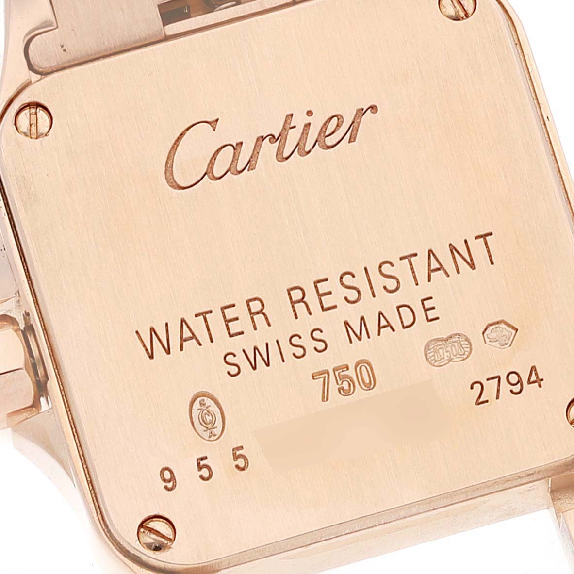 This image shows the back of the Cartier Santos Demoiselle WF9011Z8 Women's Rose Gold Silver Dial WF9011Z8 Women's Rose Gold Silver Dial watch, featuring inscriptions including water resistance and Swiss-made details.