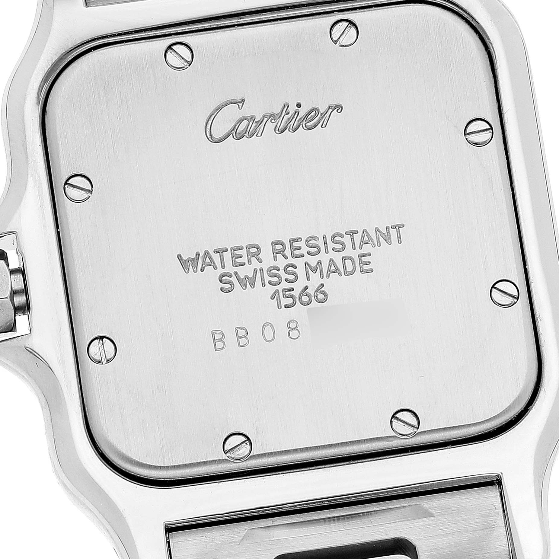 This image shows the back case and engraving of a Santos model watch by Cartier from an angled close-up view.