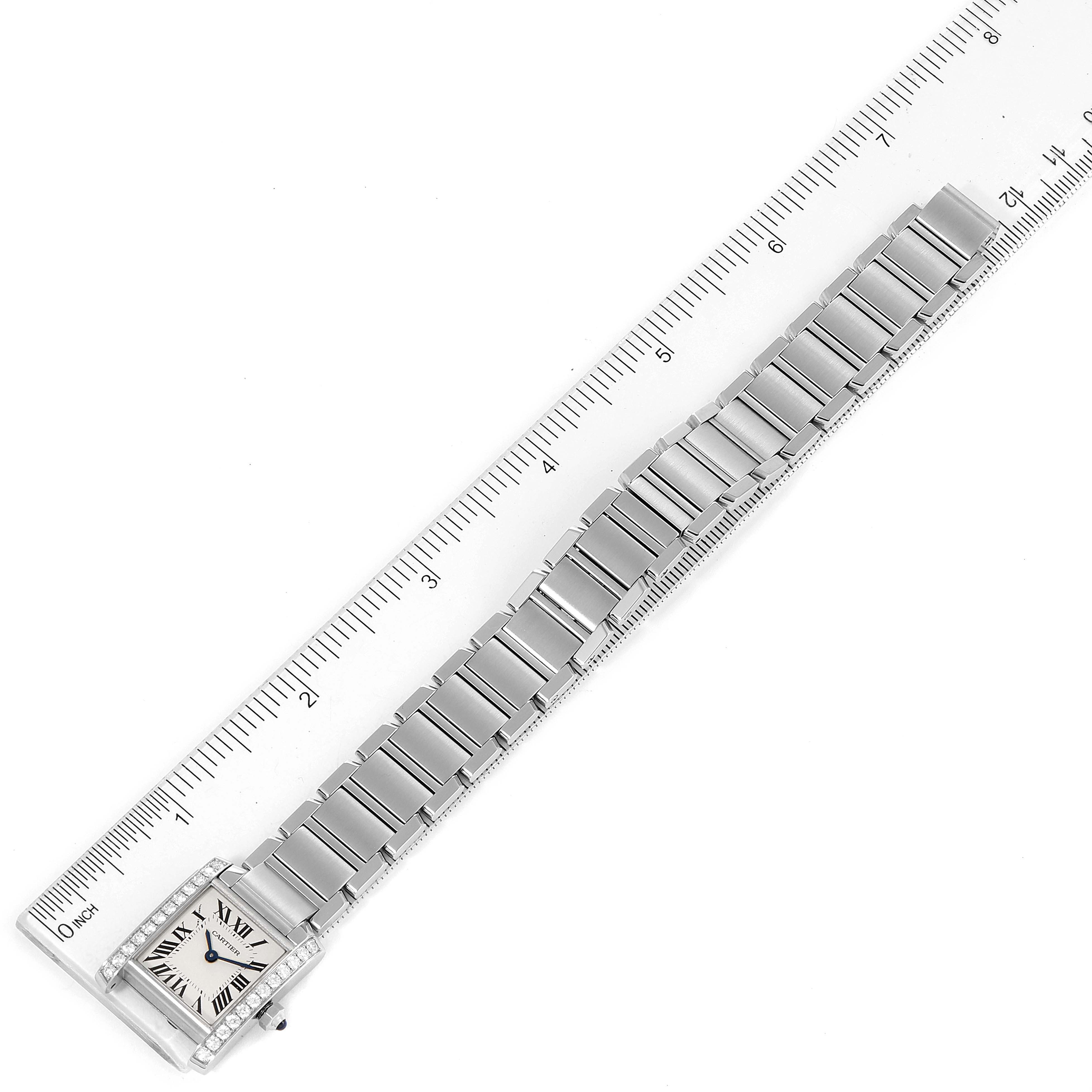 The Cartier Tank Francaise W4TA0008 Women
s Stainless Steel Silver Dial W4TA0008 Women
s Stainless Steel Silver Dial watch is shown fully extended, including the case, bracelet, and a portion of a ruler for measurement.