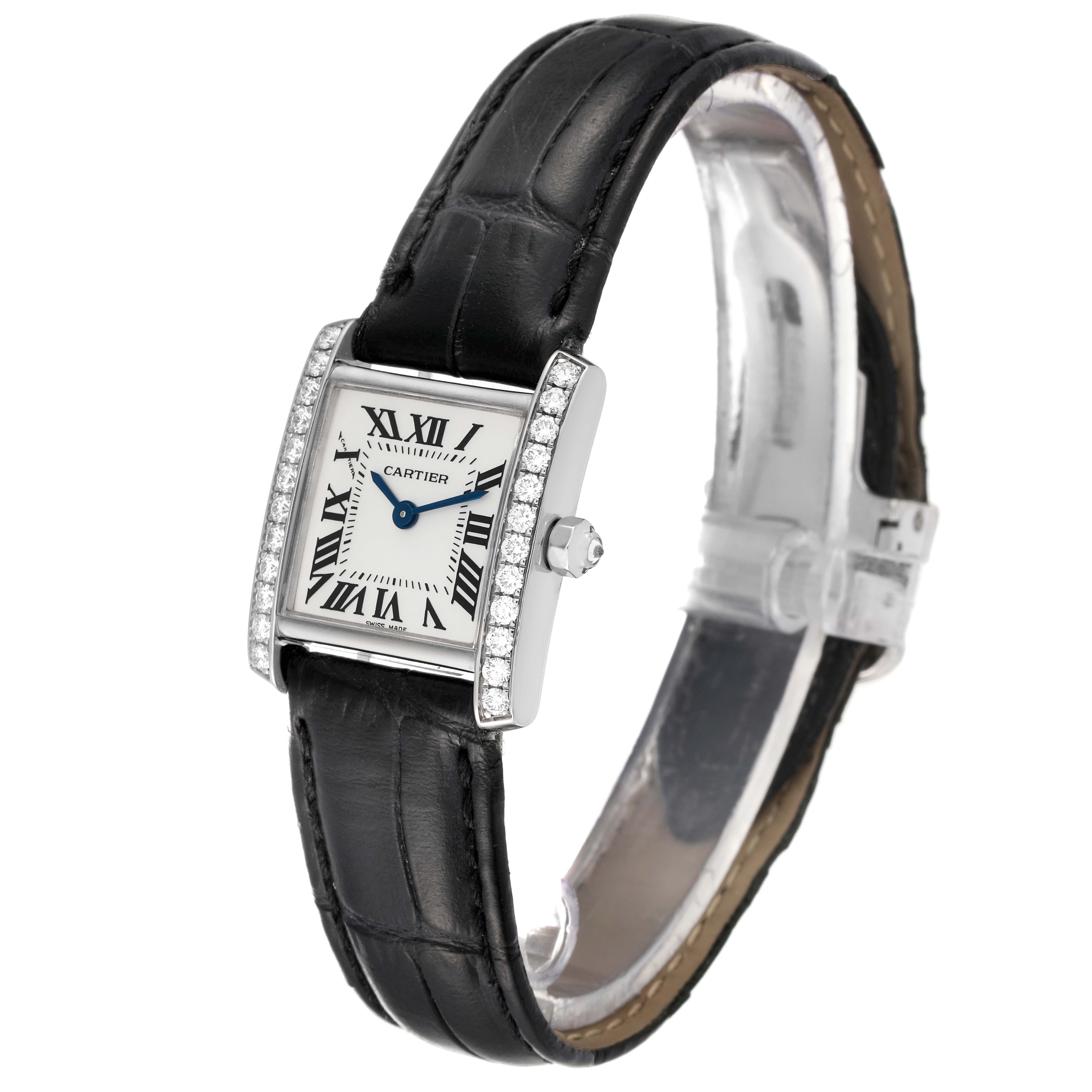 The Cartier Tank Française watch is shown at an angle, displaying the face, bezel, and black leather strap.