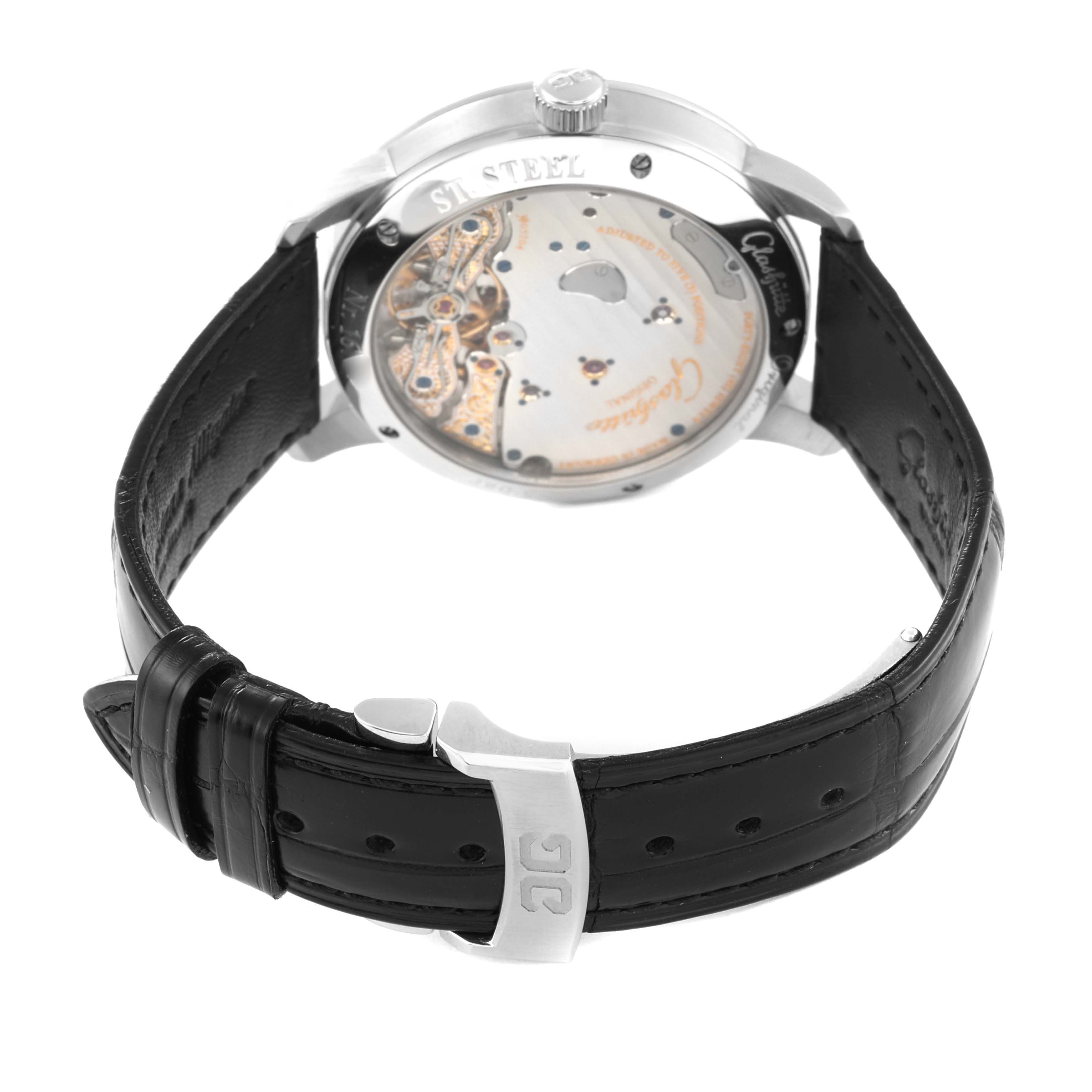 The image shows the back view of a Glashütte Pano model watch, showcasing its movement, black leather strap, and clasp.