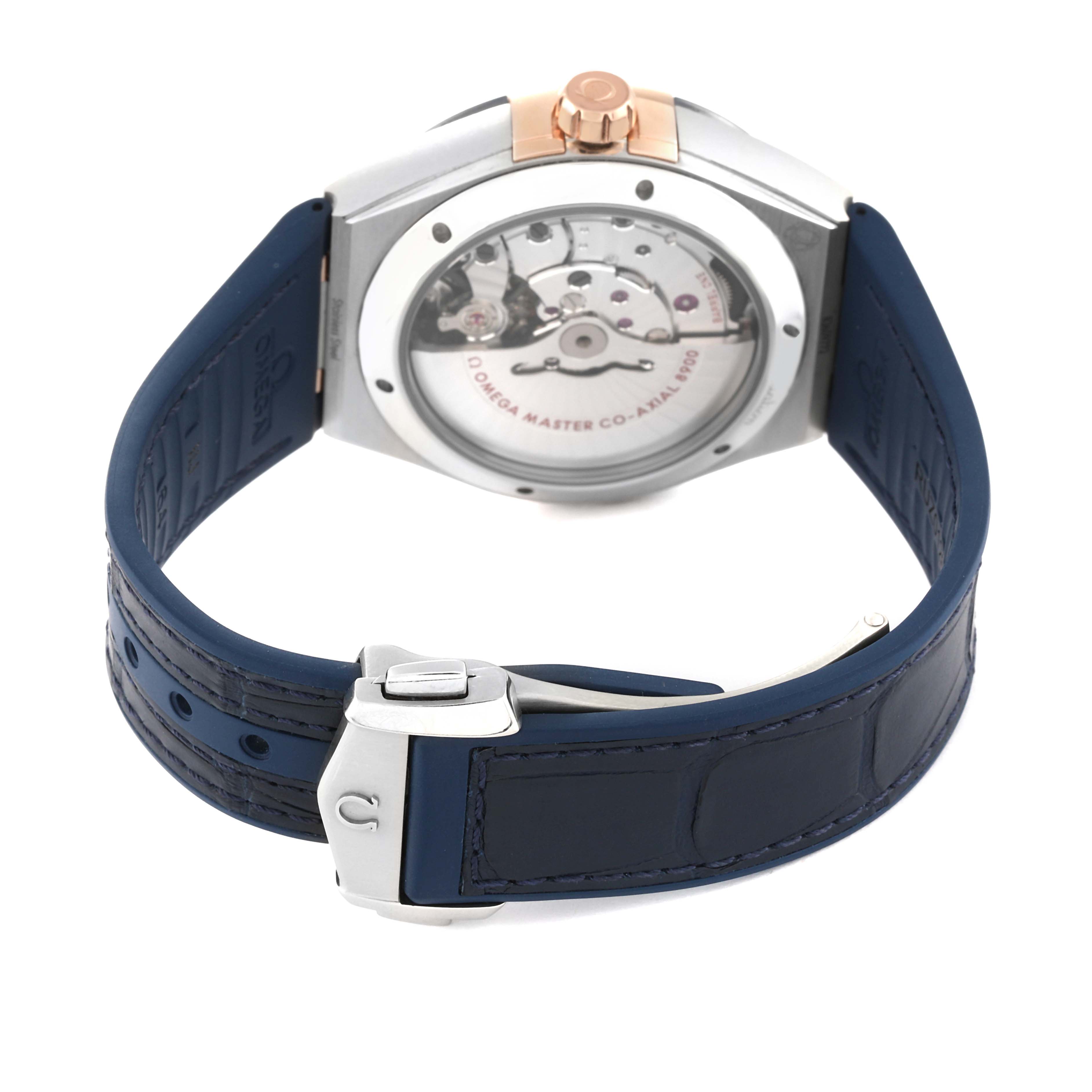 The image shows the back and clasp of an Omega Constellation 131.23.41.21.03.001 Men's Steel and Gold (two tone) Blue Dial 131.23.41.21.03.001 Men's Steel and Gold (two tone) Blue Dial watch, highlighting its movement and blue strap.