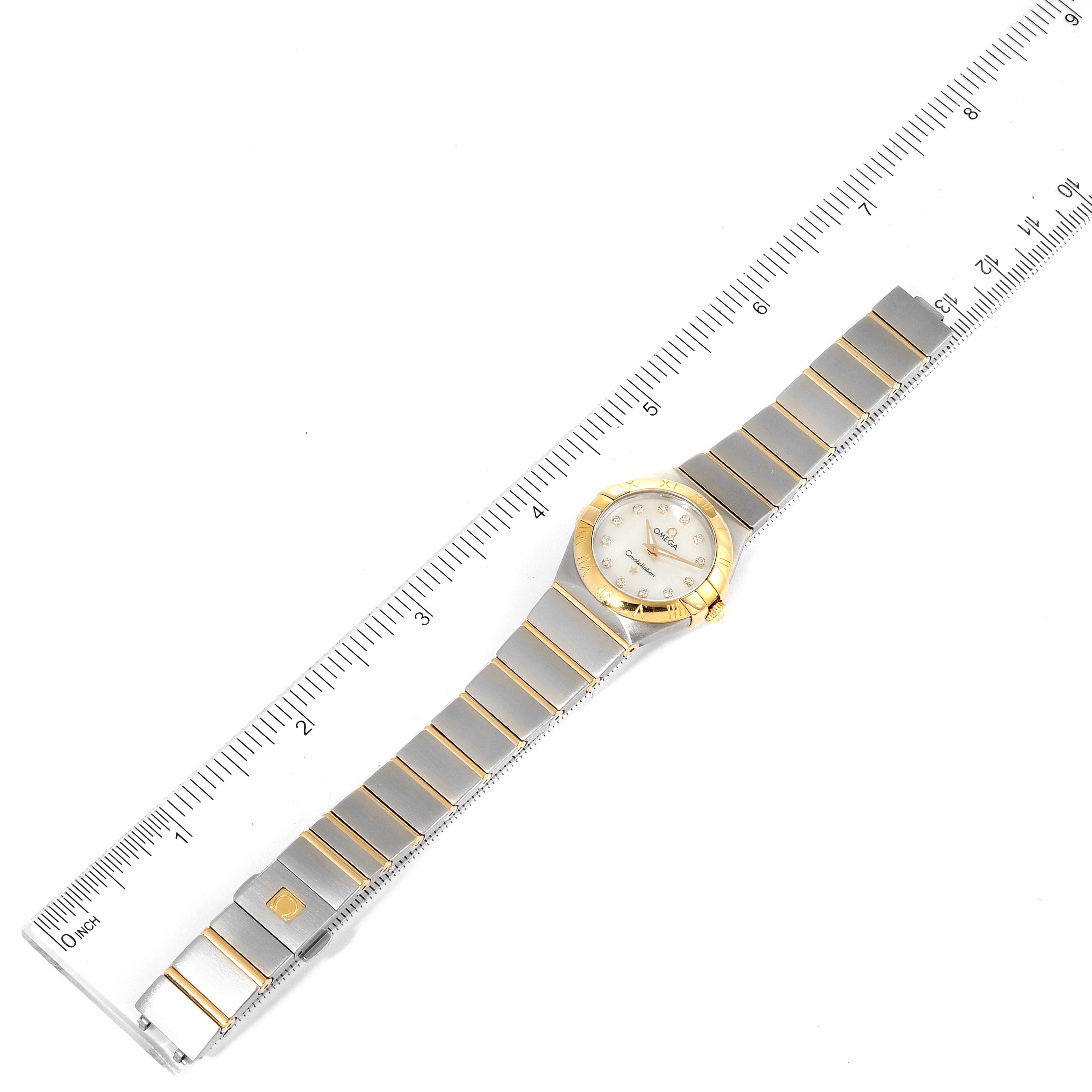 This image shows an overhead view of the Omega 123.20.24.60.55.001 Women
s Steel and Gold (two tone) Mother of Pearl Dial 123.20.24.60.55.001 Women
s Steel and Gold (two tone) Mother of Pearl Dial Constellation Steel Gold MOP Diamond Watch 123.20.24.60.55.001 alongside a measuring ruler.