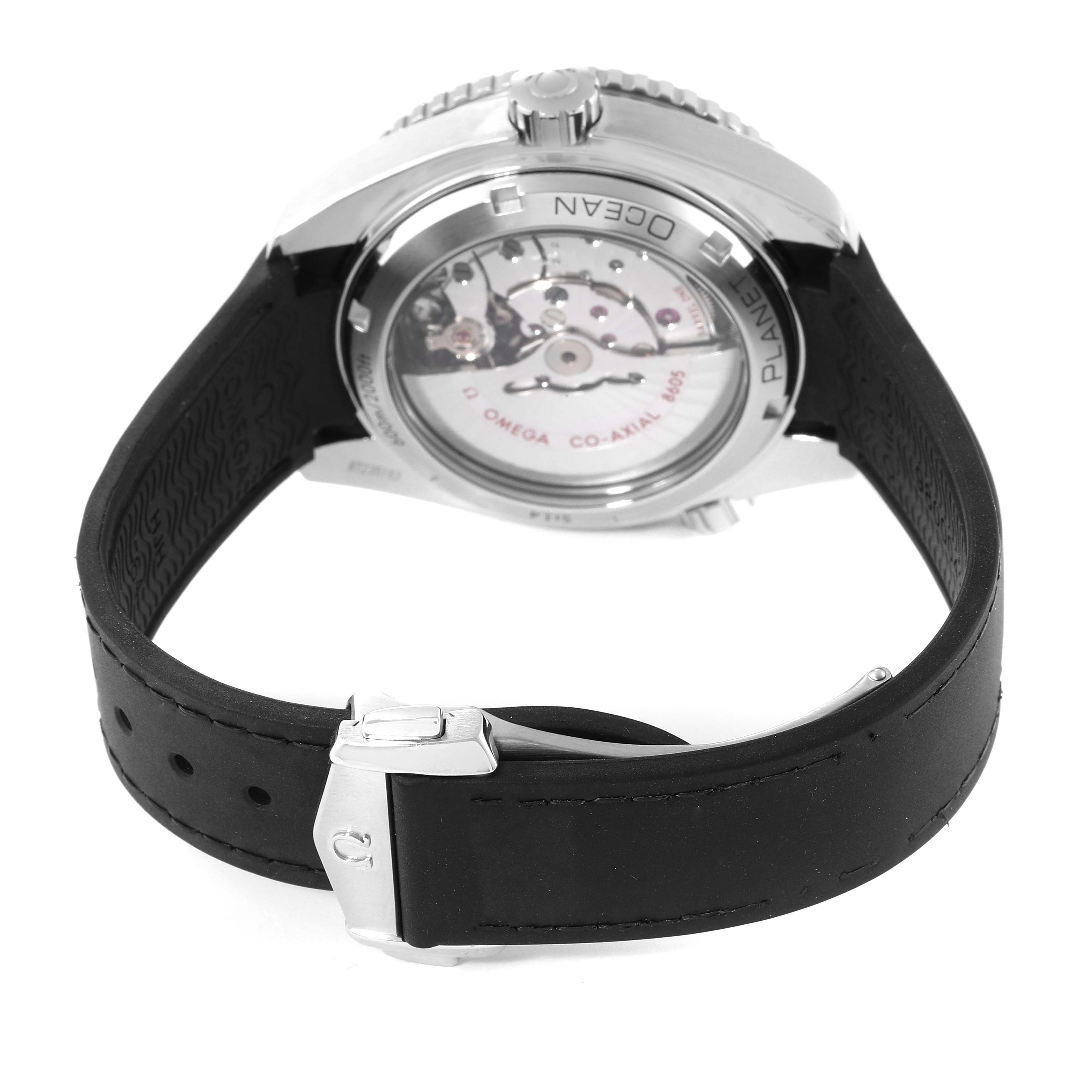 In the image, the Omega Planet Ocean 232.30.44.22.01.001 Men's Stainless Steel Black Dial 232.30.44.22.01.001 Men's Stainless Steel Black Dial watch is shown from the rear, highlighting the transparent case back and black strap.