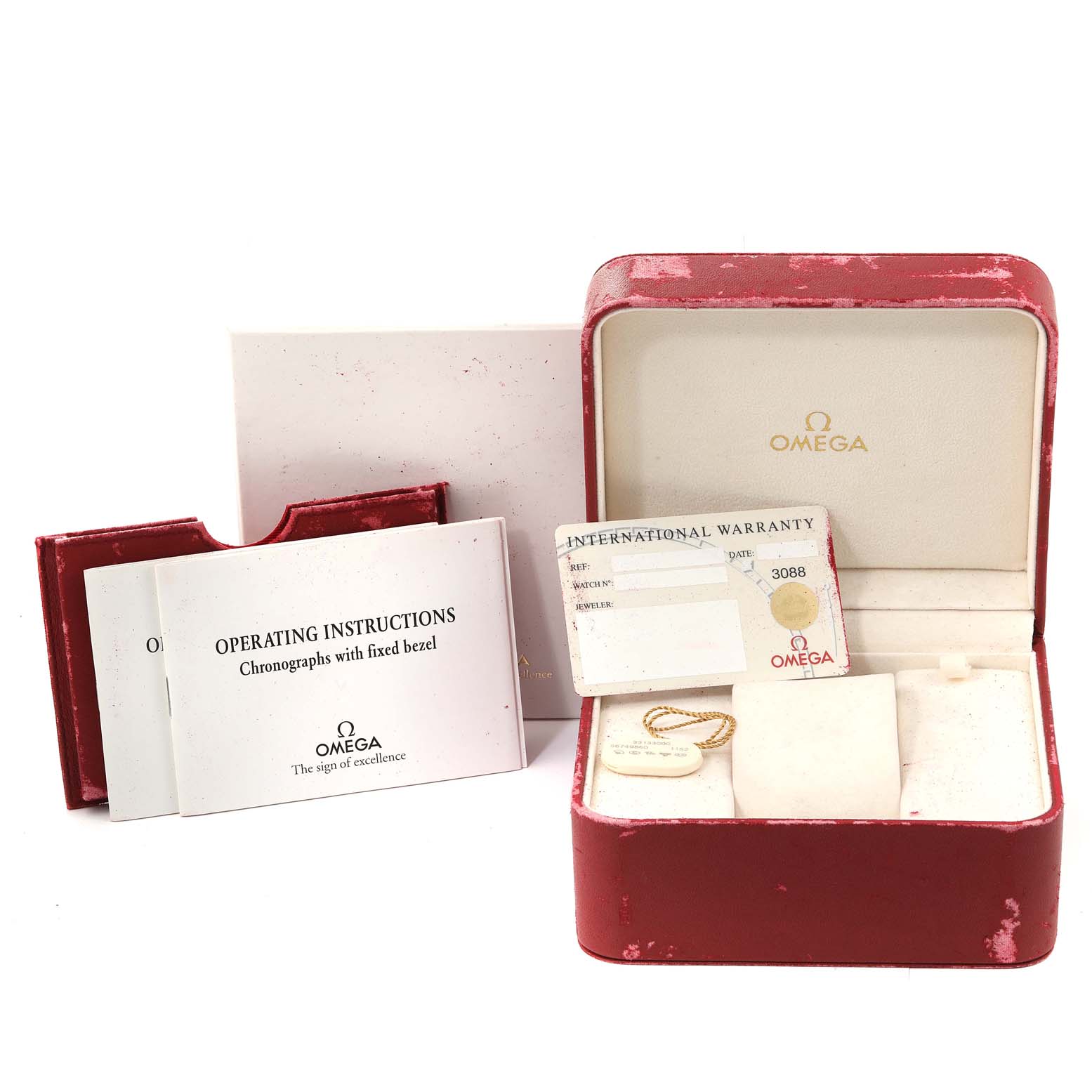 The image shows a red Omega Speedmaster 3313.30.00 Men's Steel and Gold (two tone) Silver Dial 3313.30.00 Men's Steel and Gold (two tone) Silver Dial watch box, operating instructions, warranty card, and tag.