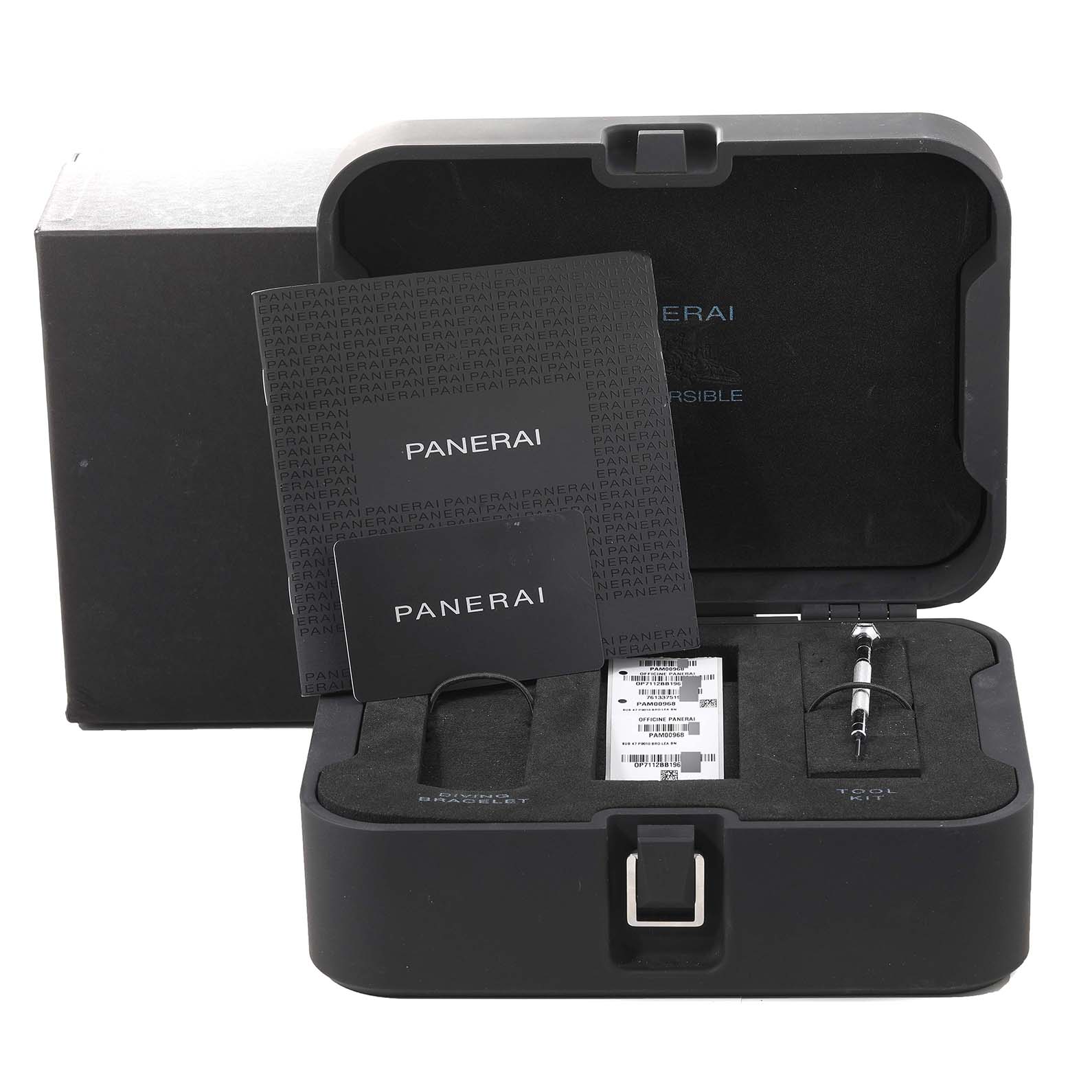 The image shows an open Panerai Submersible PAM00968 Men's Bronze Brown Dial PAM00968 Men's Bronze Brown Dial watch box with a book, card, tool, and slots for accessories.