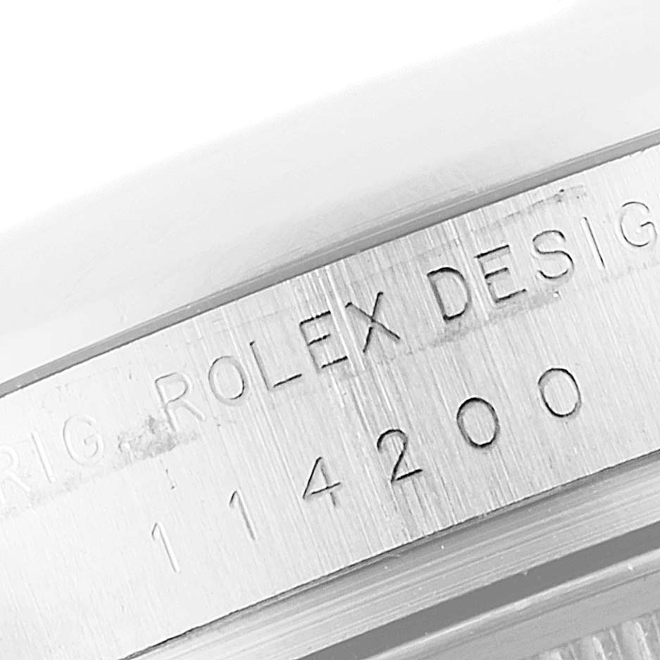 This image shows a close-up of the case side engraving on a Rolex Air-King 114200 Men's Stainless Steel Blue Dial 114200 Men's Stainless Steel Blue Dial watch, displaying the model number.
