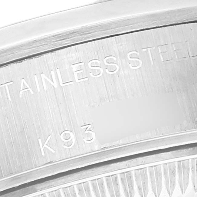 This close-up image shows a portion of the stainless steel case back of a Rolex Datejust 79160 Women's Stainless Steel White Dial 79160 Women's Stainless Steel White Dial watch.