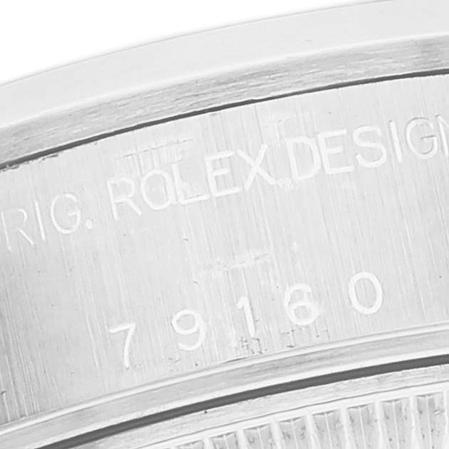 This image shows a close-up view of the Rolex Datejust 79160 Women's Stainless Steel White Dial 79160 Women's Stainless Steel White Dial model's case with engravings, including the model number.
