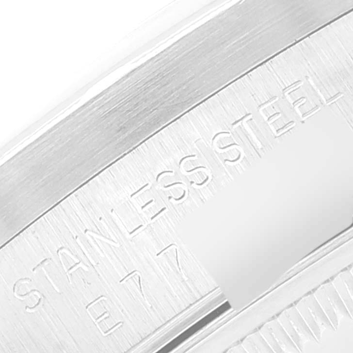 The image shows a close-up of the stainless steel case back of a Rolex Date 15210 Men
s Stainless Steel Silver Dial 15210 Men
s Stainless Steel Silver Dial model watch with etched serial numbers partially visible.