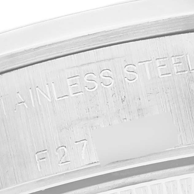 This image shows a close-up of the case-back edge of a Rolex Date 79160 Women's Stainless Steel Silver Dial 79160 Women's Stainless Steel Silver Dial model watch, highlighting the "STAINLESS STEEL" engraving.