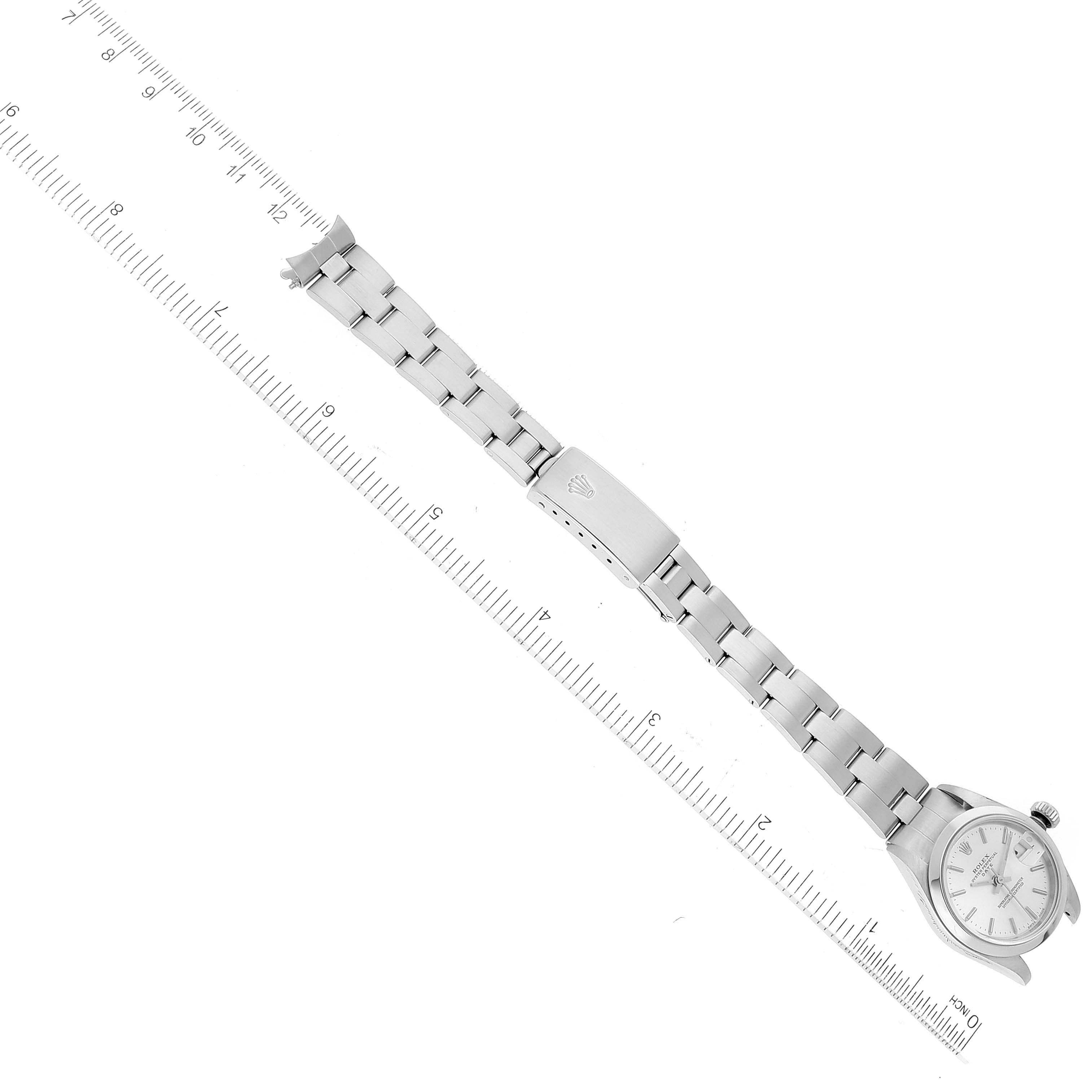 The image shows a top-down view of a Rolex Date 79160 Women's Stainless Steel Silver Dial 79160 Women's Stainless Steel Silver Dial model watch with a focus on the watch bracelet and clasp.