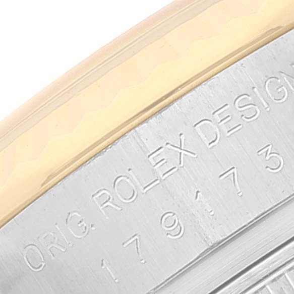 This image shows a close-up angle of the side engraving on a Rolex Datejust 179173 Women's Steel and Gold (two tone) White Dial 179173 Women's Steel and Gold (two tone) White Dial model watch.